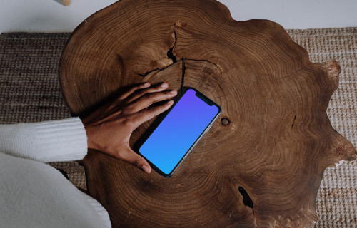 iPhone mockup on a wooden table