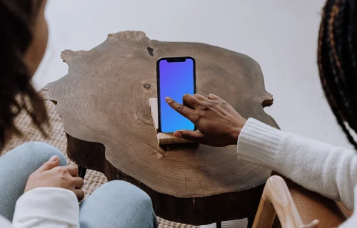 iPhone mockup on wooden center table