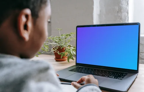 Little boy using a gray MacBook Pro mockup