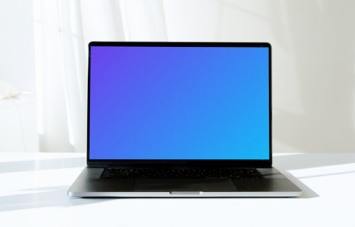 MacBook Pro mockup in full view on a white table