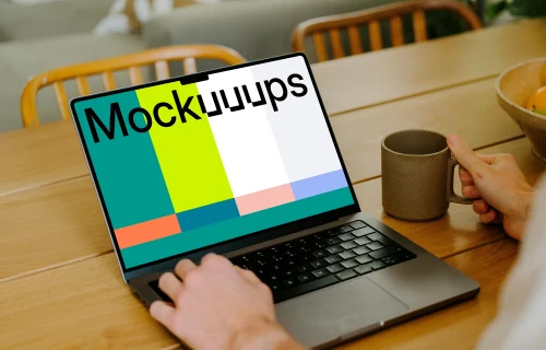 MacBook Pro mockup on a table in front of a user