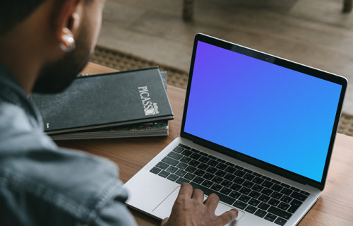 Man shopping on his grey MacBook mockup