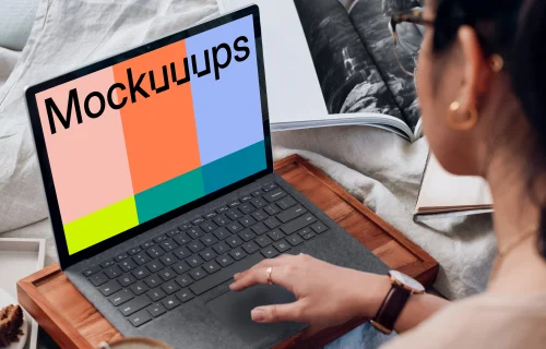 Microsoft Surface Laptop mockup used by a lady on a wooden slab