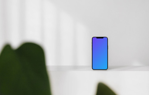Minimal iPhone mockup on a white wall