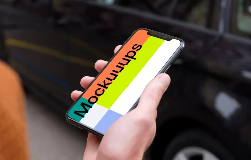 Passenger walking towards a car holding an iPhone 11 mockup