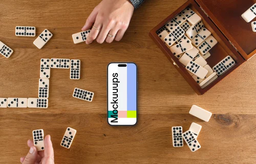 People playing dominoes next to the iPhone mockup
