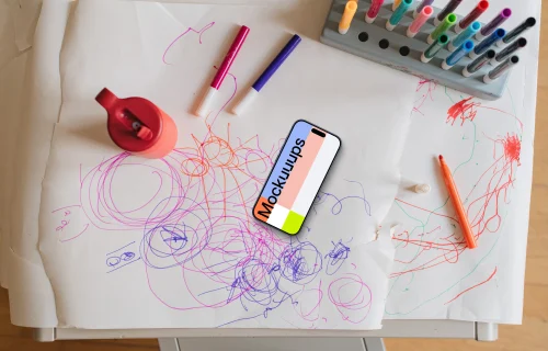 Smartphone mockup amidst colorful children's art