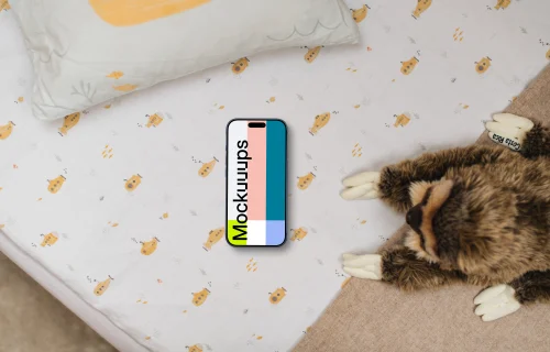 Smartphone mockup on children's bedding with plush toy