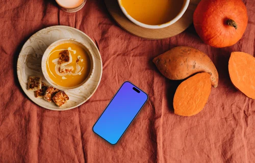 Top view of phone mockup next to the pumpkin soup
