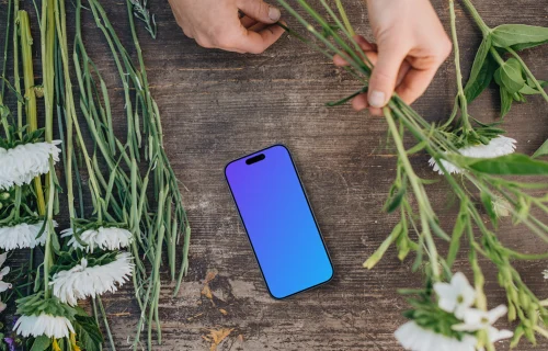Top view of smartphone mockup with flowers
