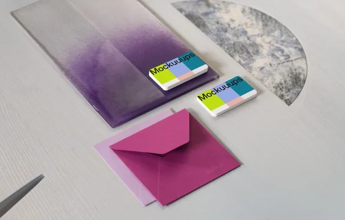 Two business cards mockup with colorful envelopes on textured surface