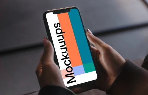 User holding an iPhone in both hands mockup