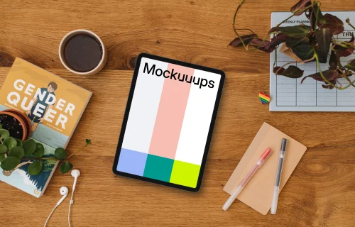 Wooden table with a tablet mockup and a pride pin