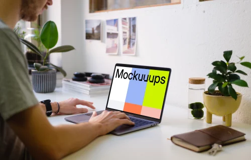 Young man working on the Macbook Pro mockup