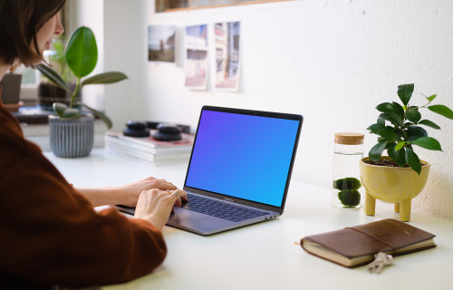 Young woman working on the Macbook Pro mockup