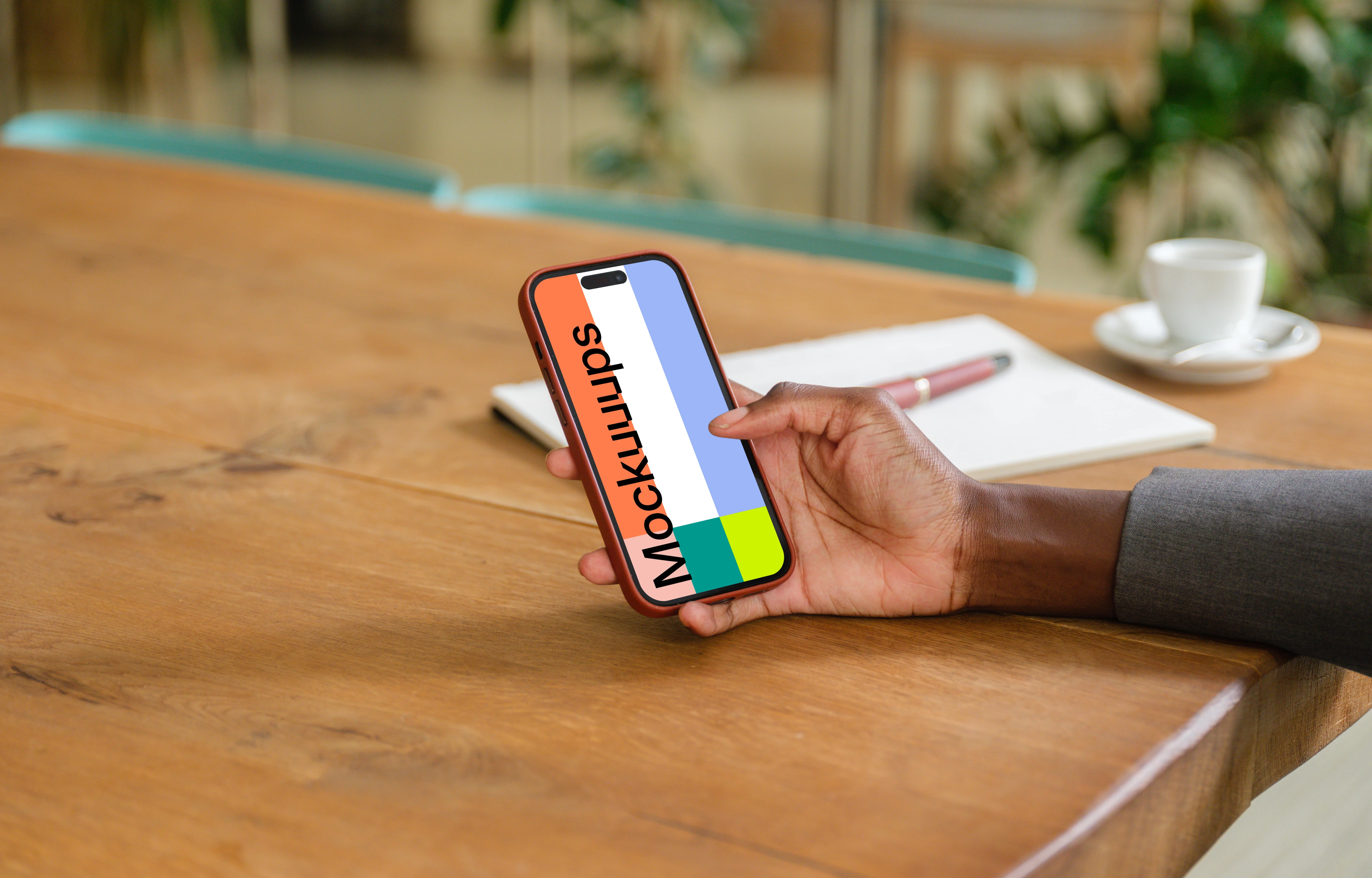 Female entrepreneur in office with iPhone in her hand