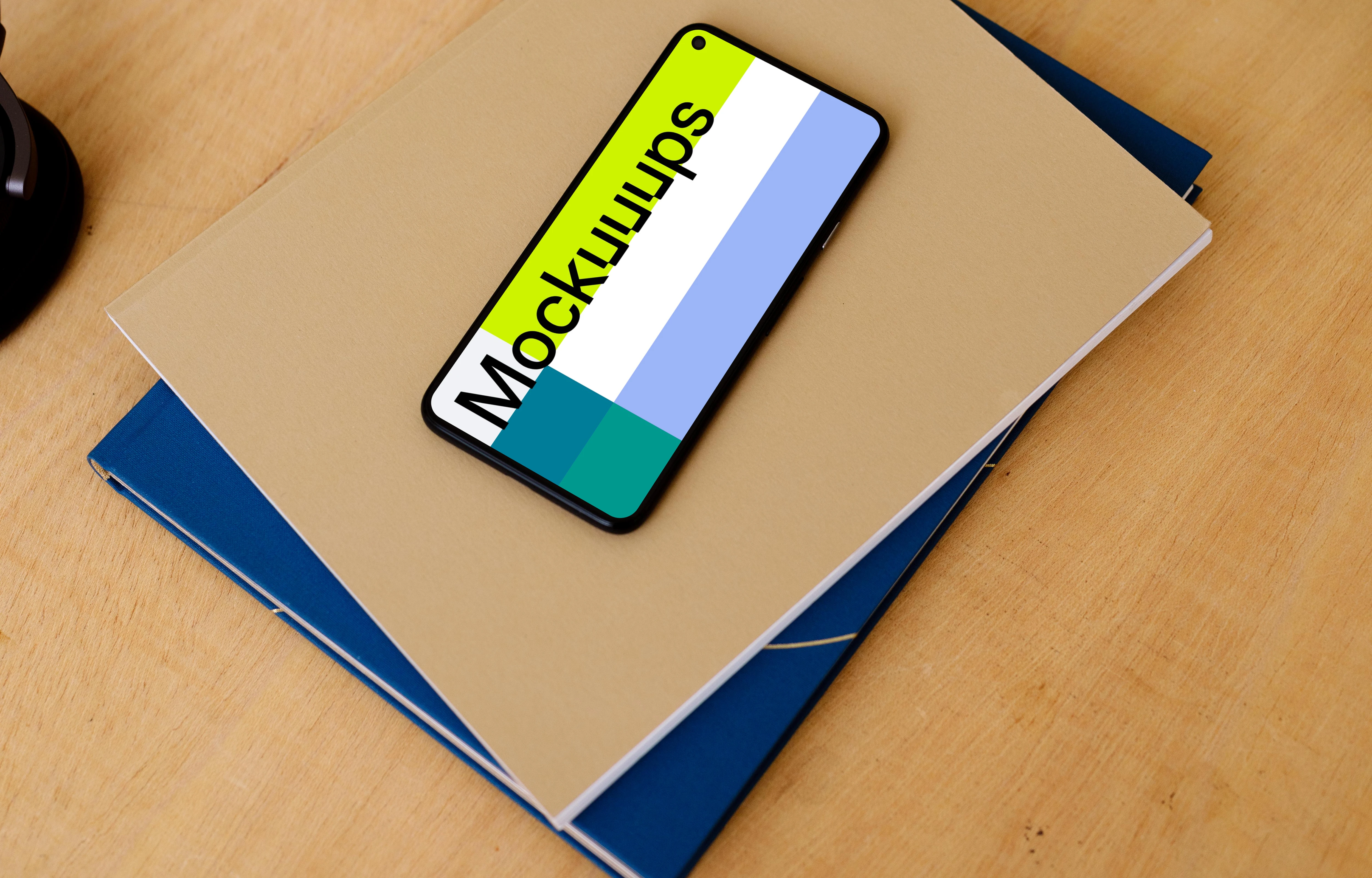Google Pixel mockup stacked on a pair of notepads