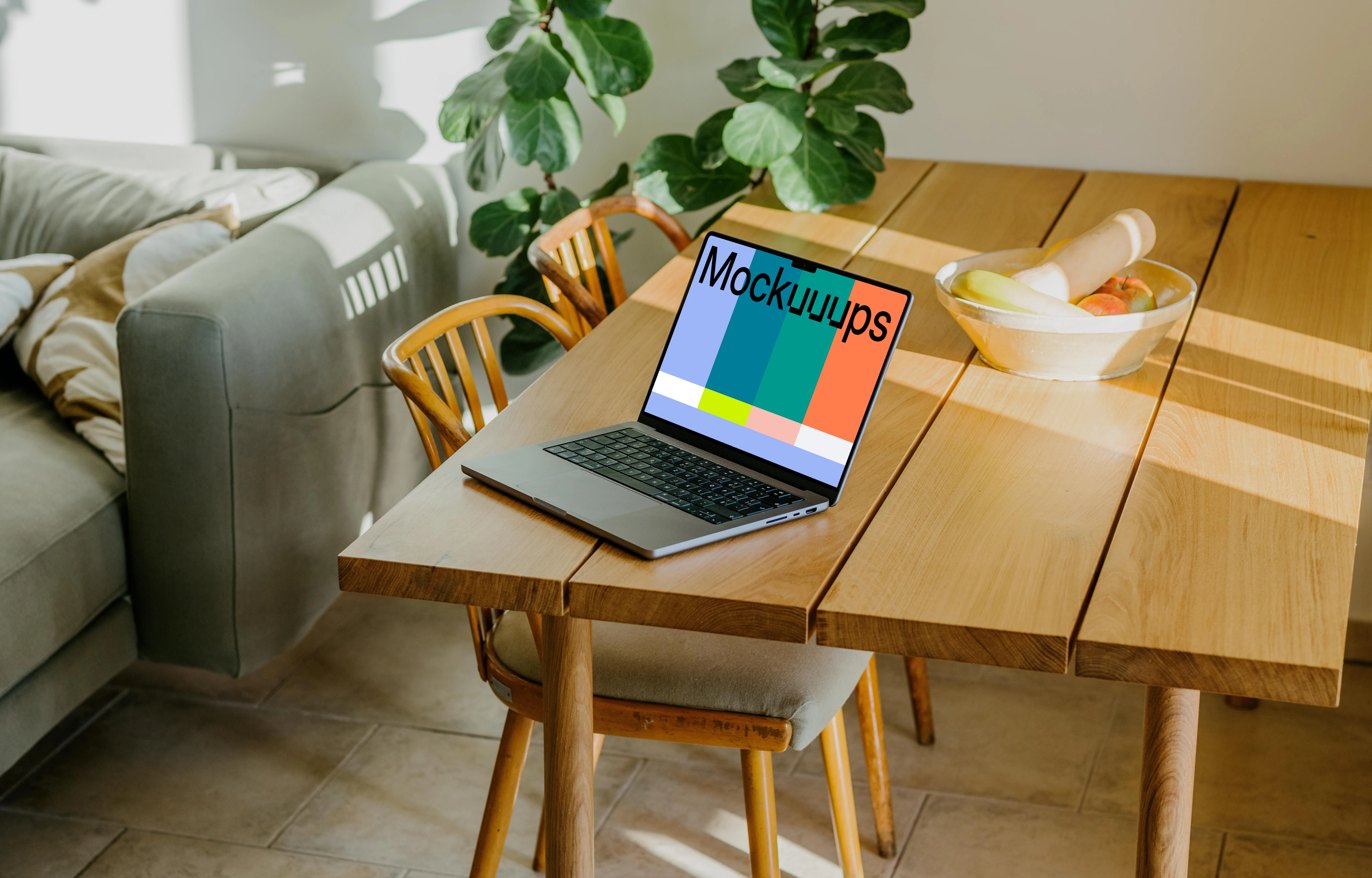 Grey MacBook Pro mockup at the edge of a table