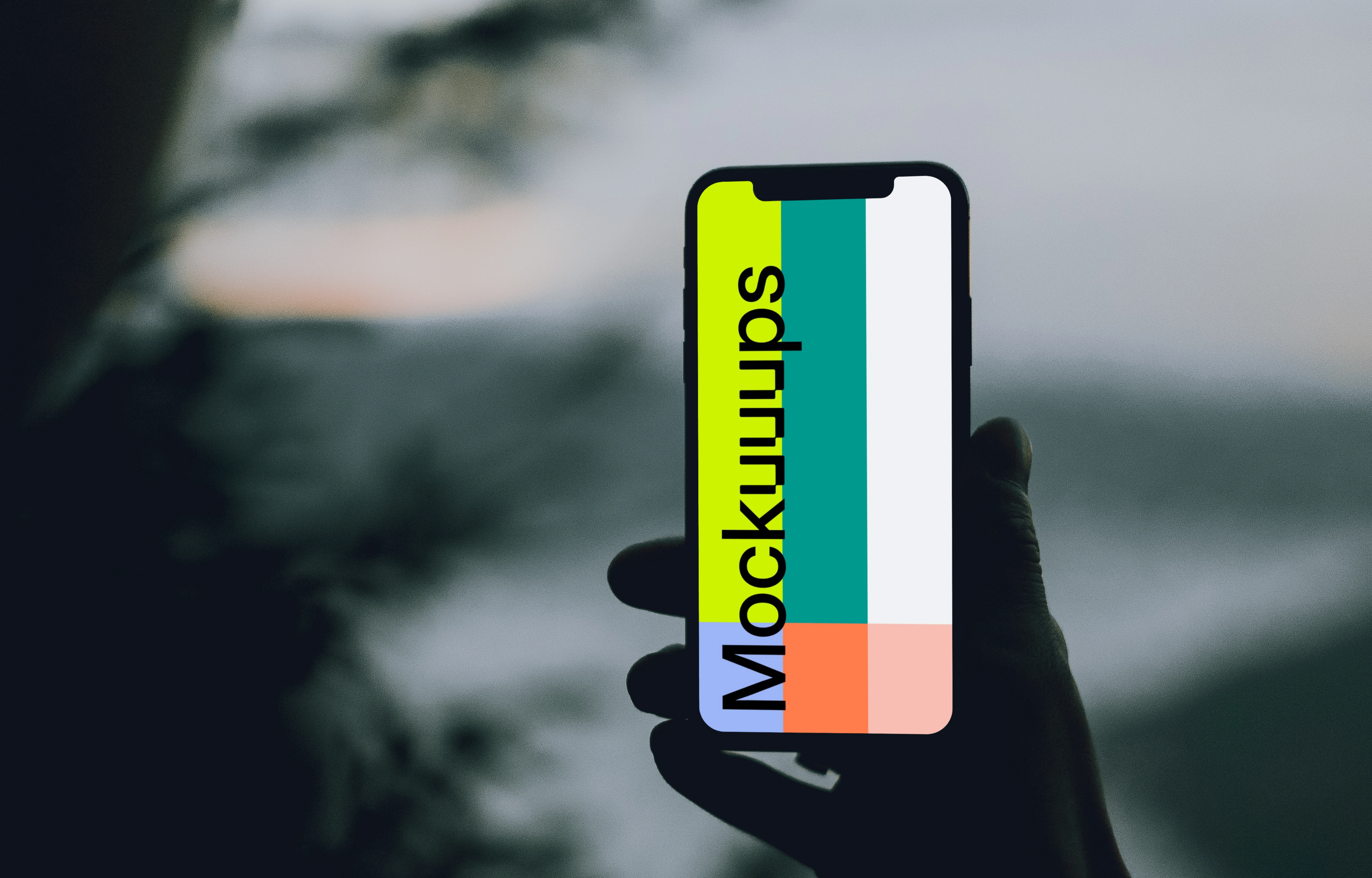 iPhone 12 Pro mockup held by a user