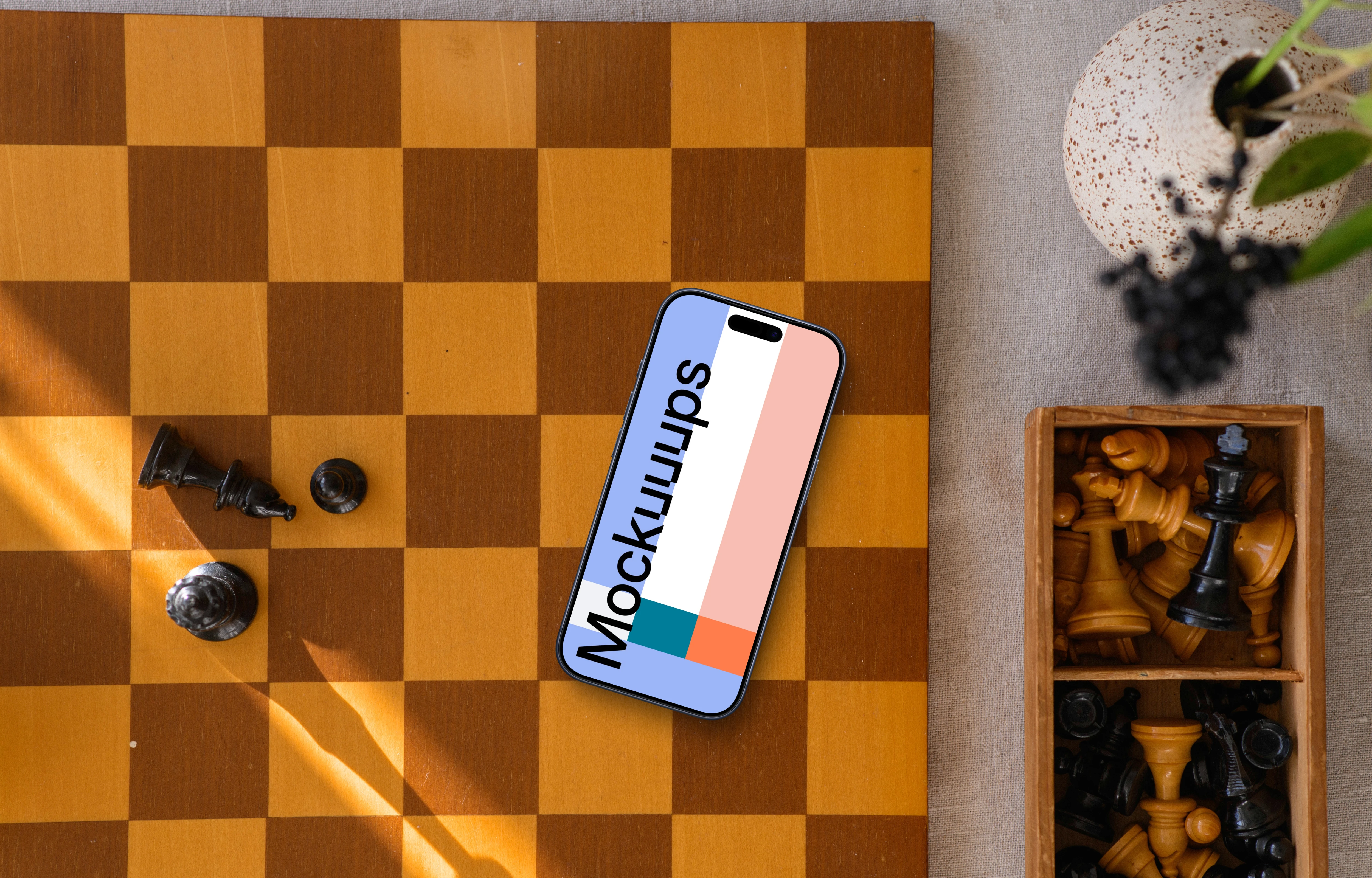 iPhone mockup laying on the chess board