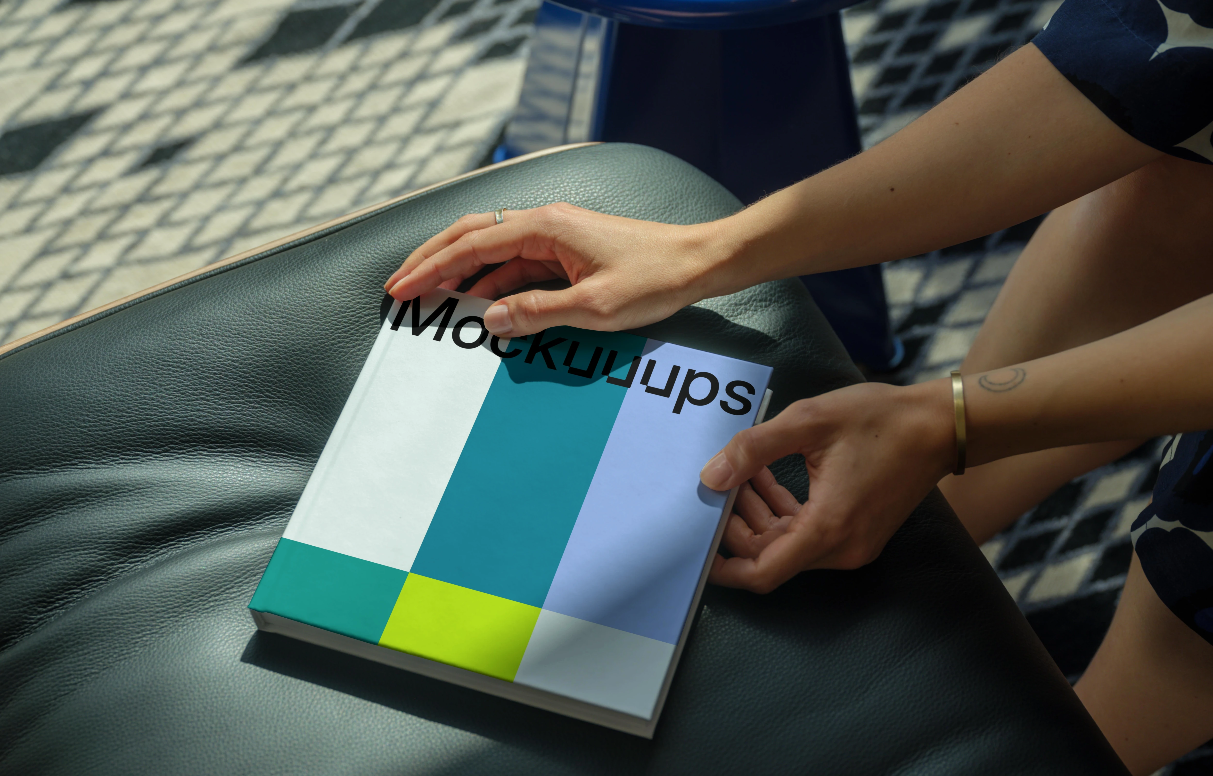 Mockup of a square book on a leather seat