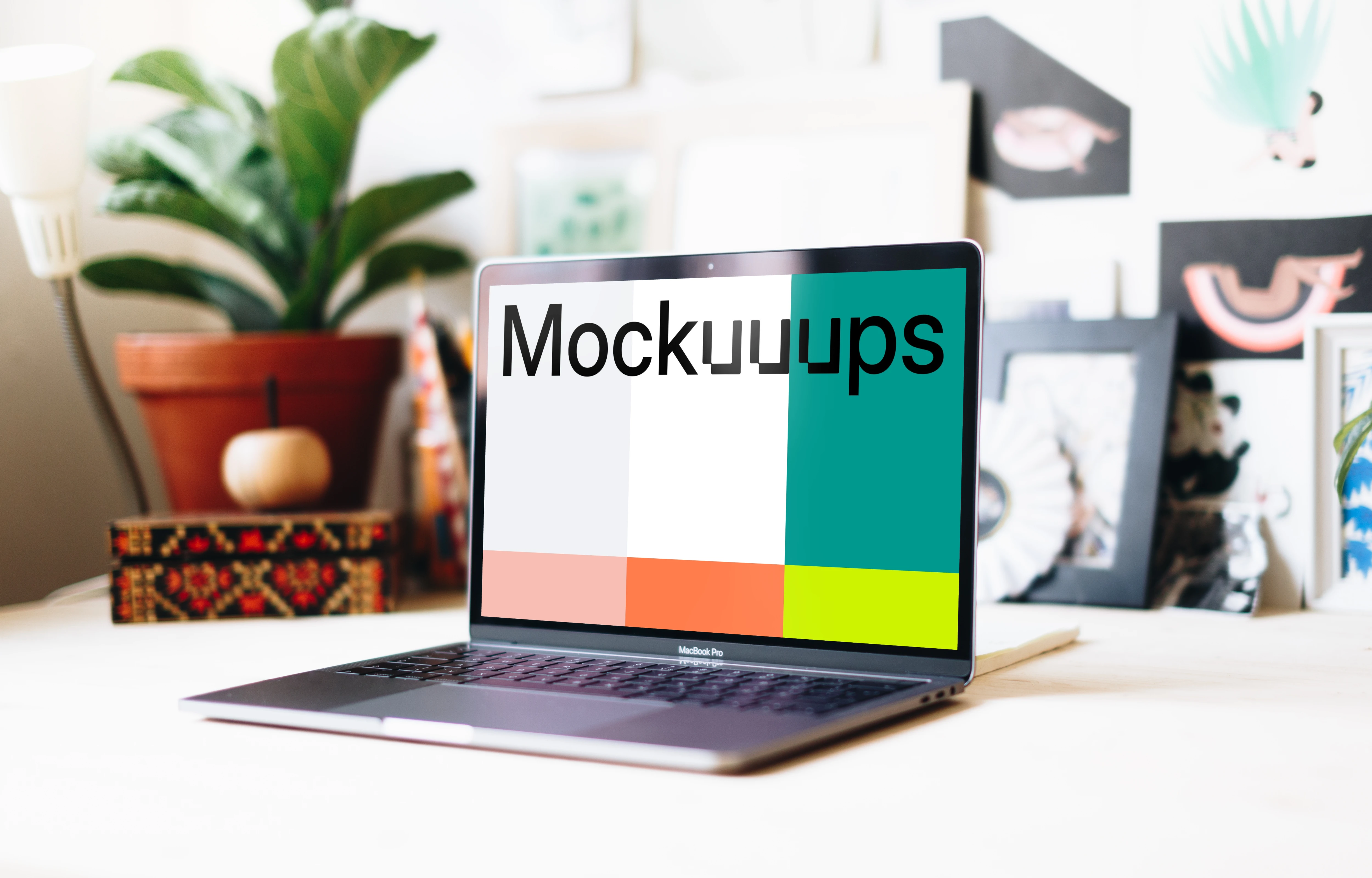 Side view of Macbook Pro mockup in a creative workspace
