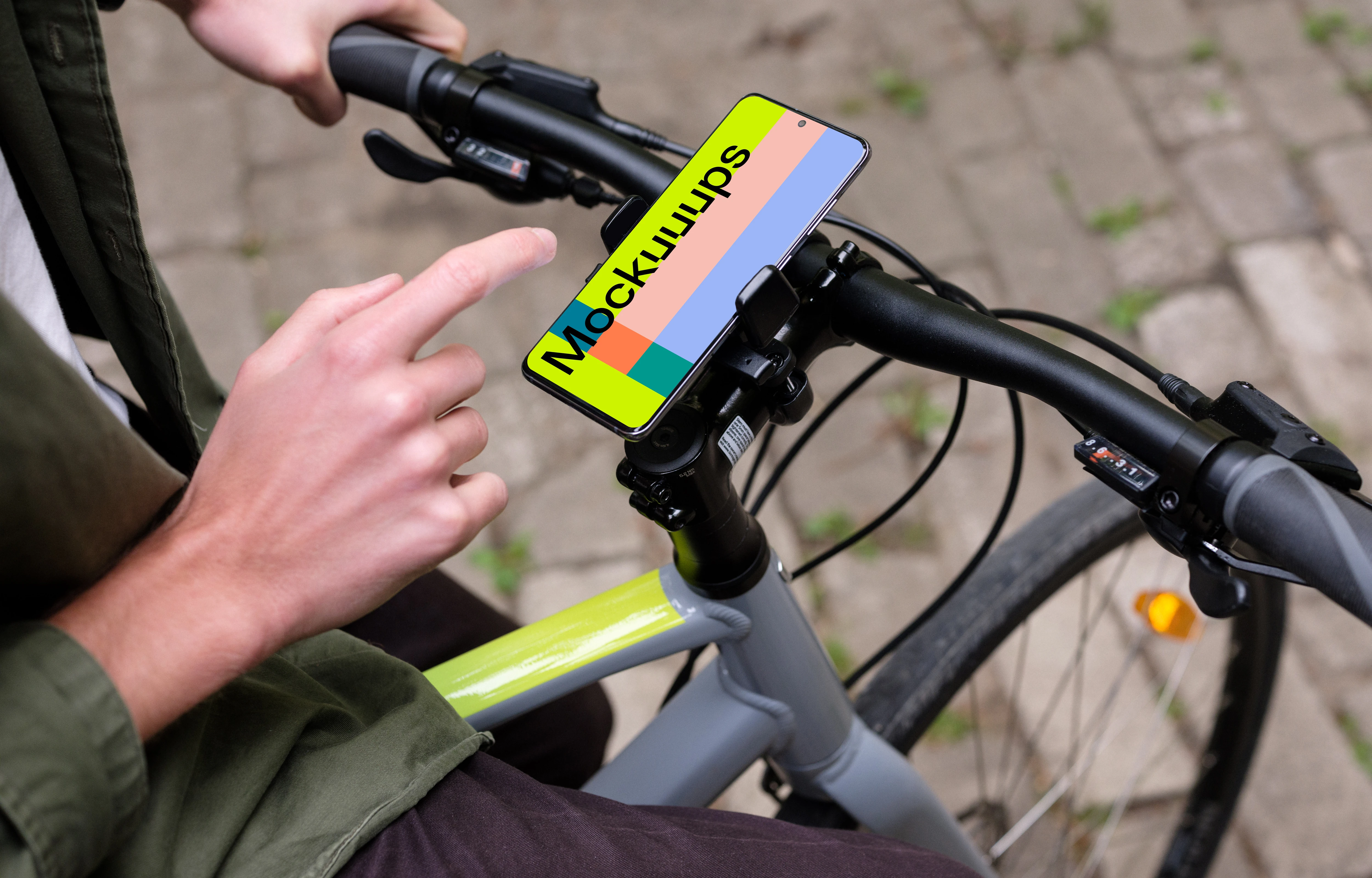 Sitting on bike tapping Samsung S20 mockup in a bike mount