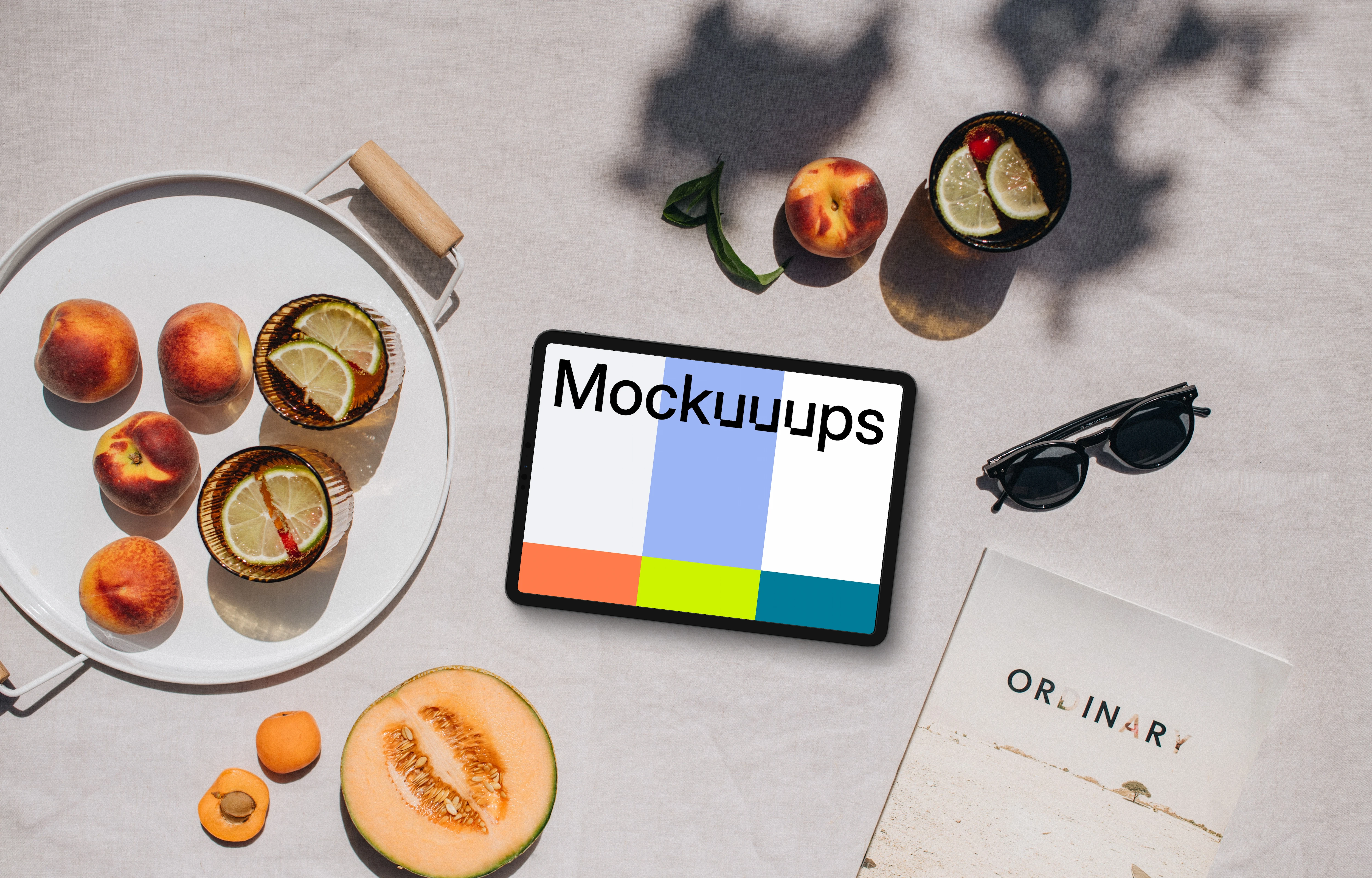 Top view of landscape tablet mockup with a magazine on the side