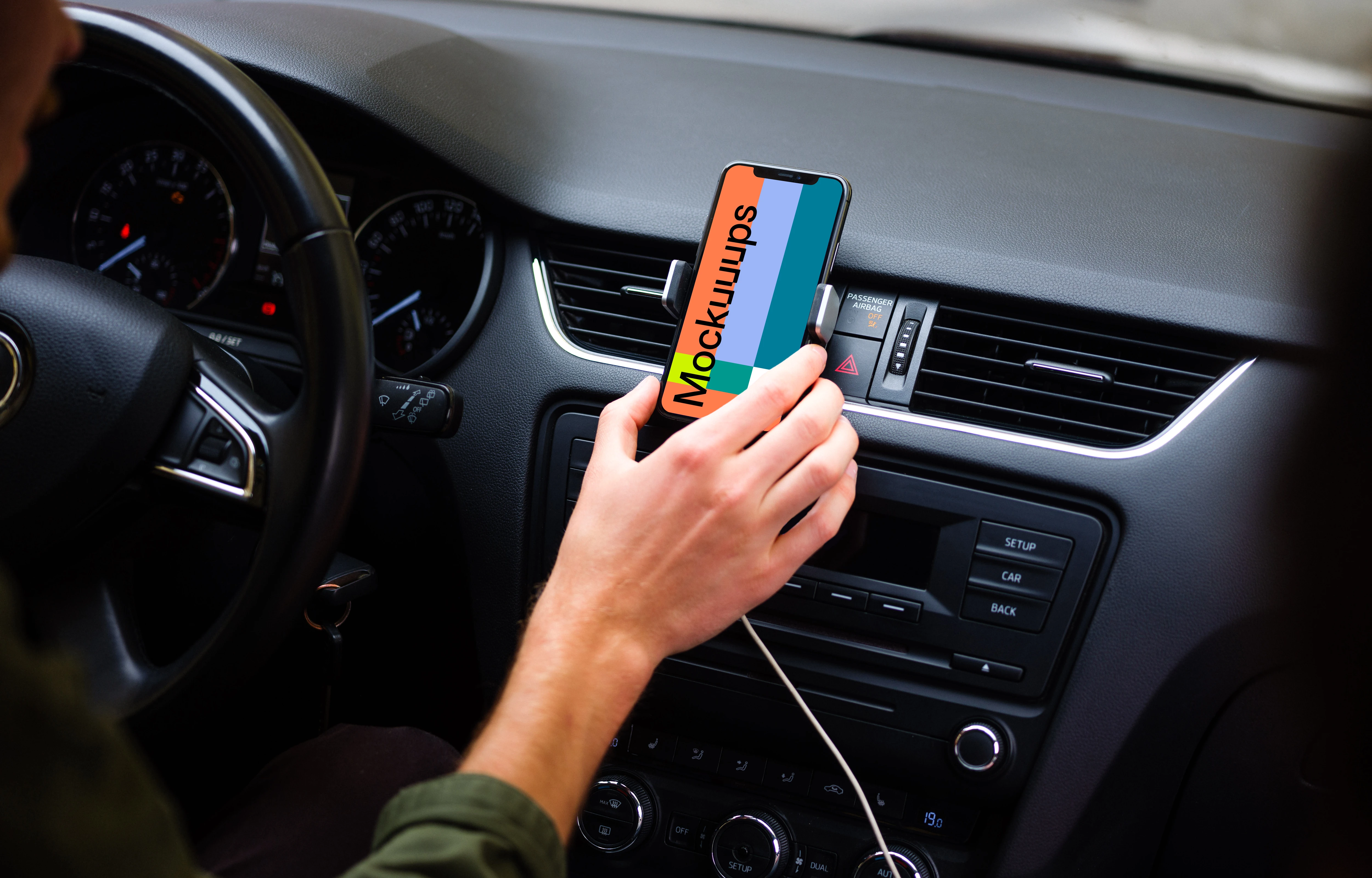 Driver placing iPhone 11 mockup in car mount