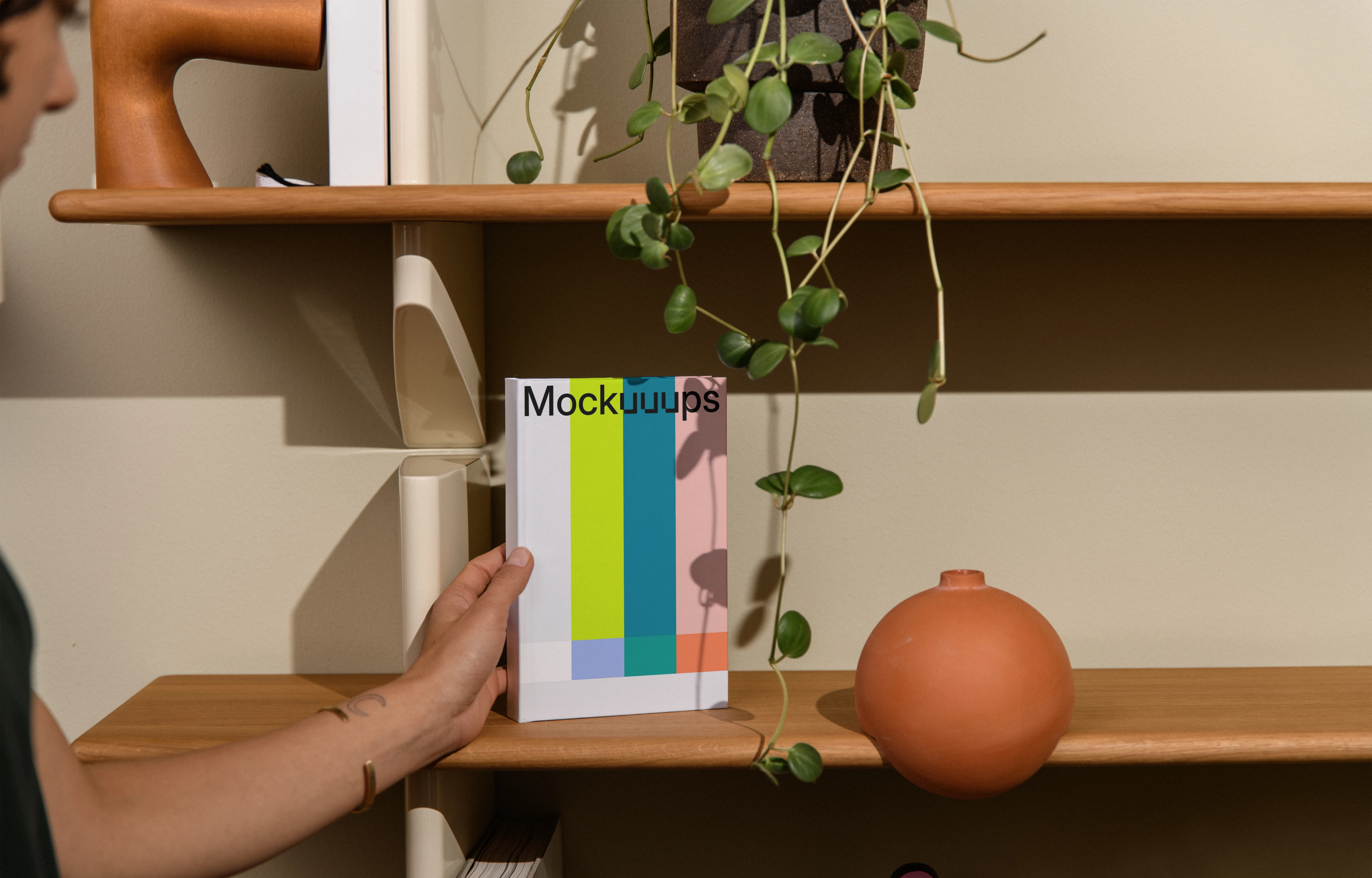 B-format book mockup on a wooden shelf with decor