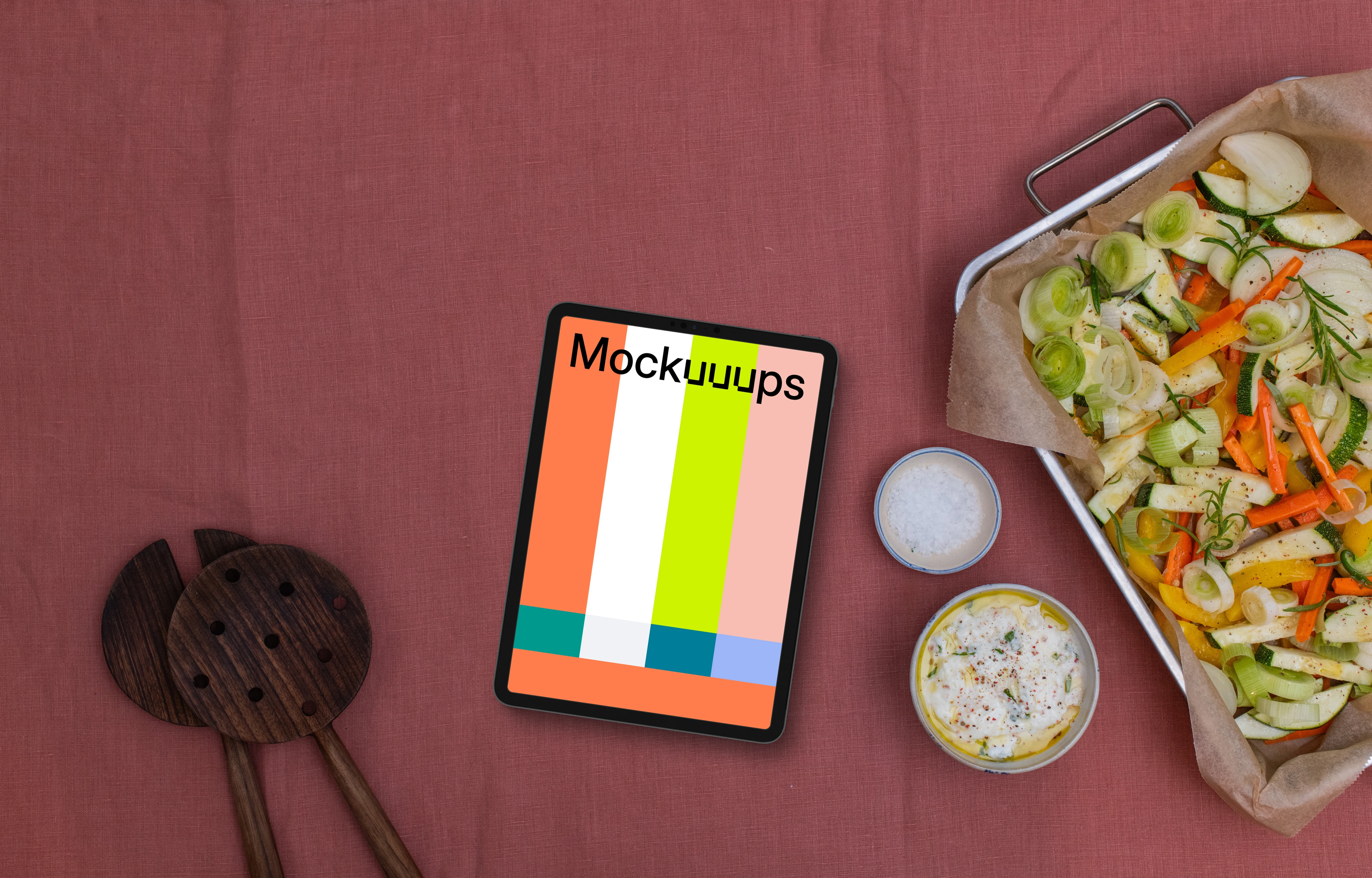 Baking pan full of vegetables and a tablet mockup