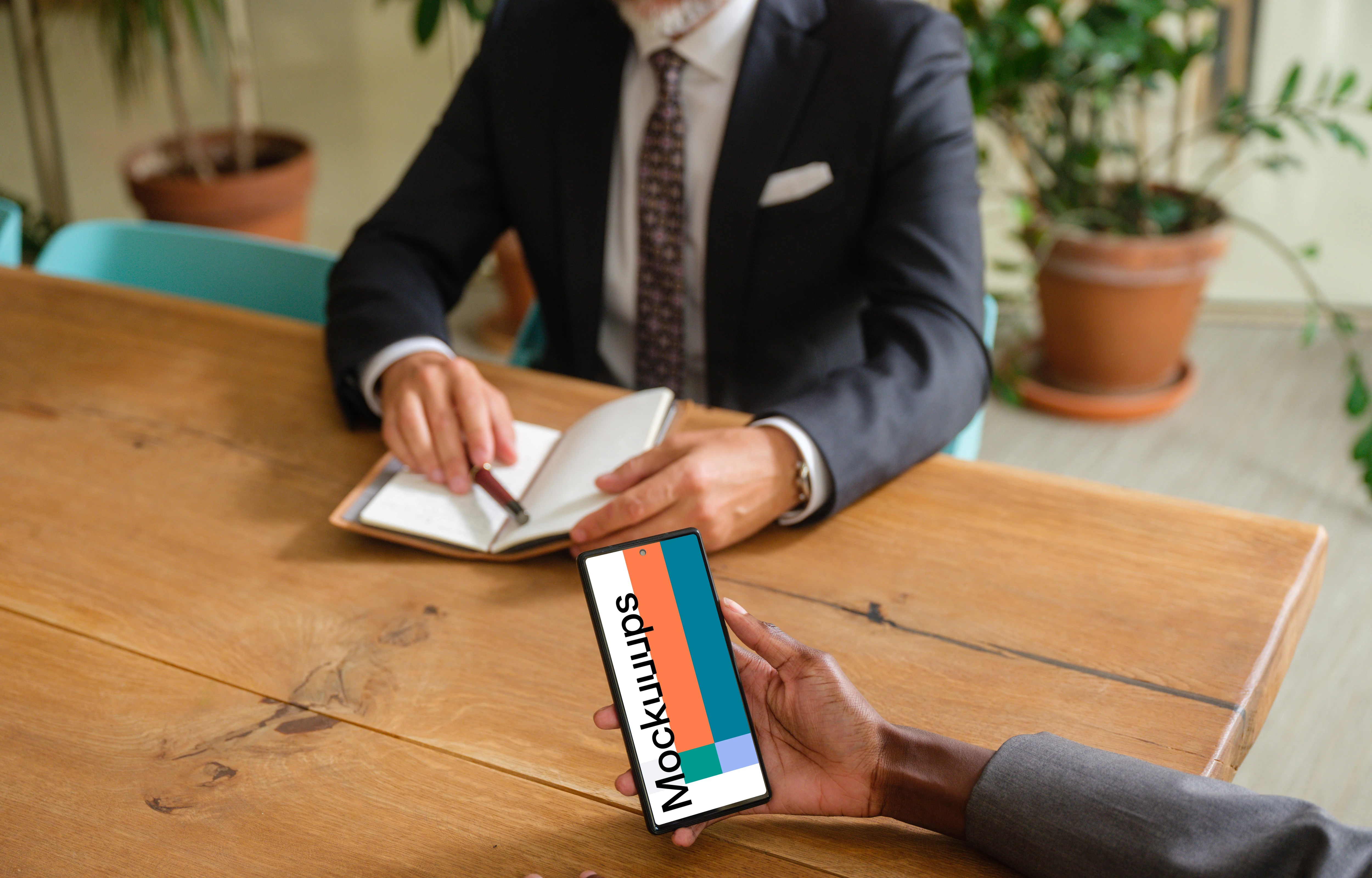 Business woman working on phone in business meeting