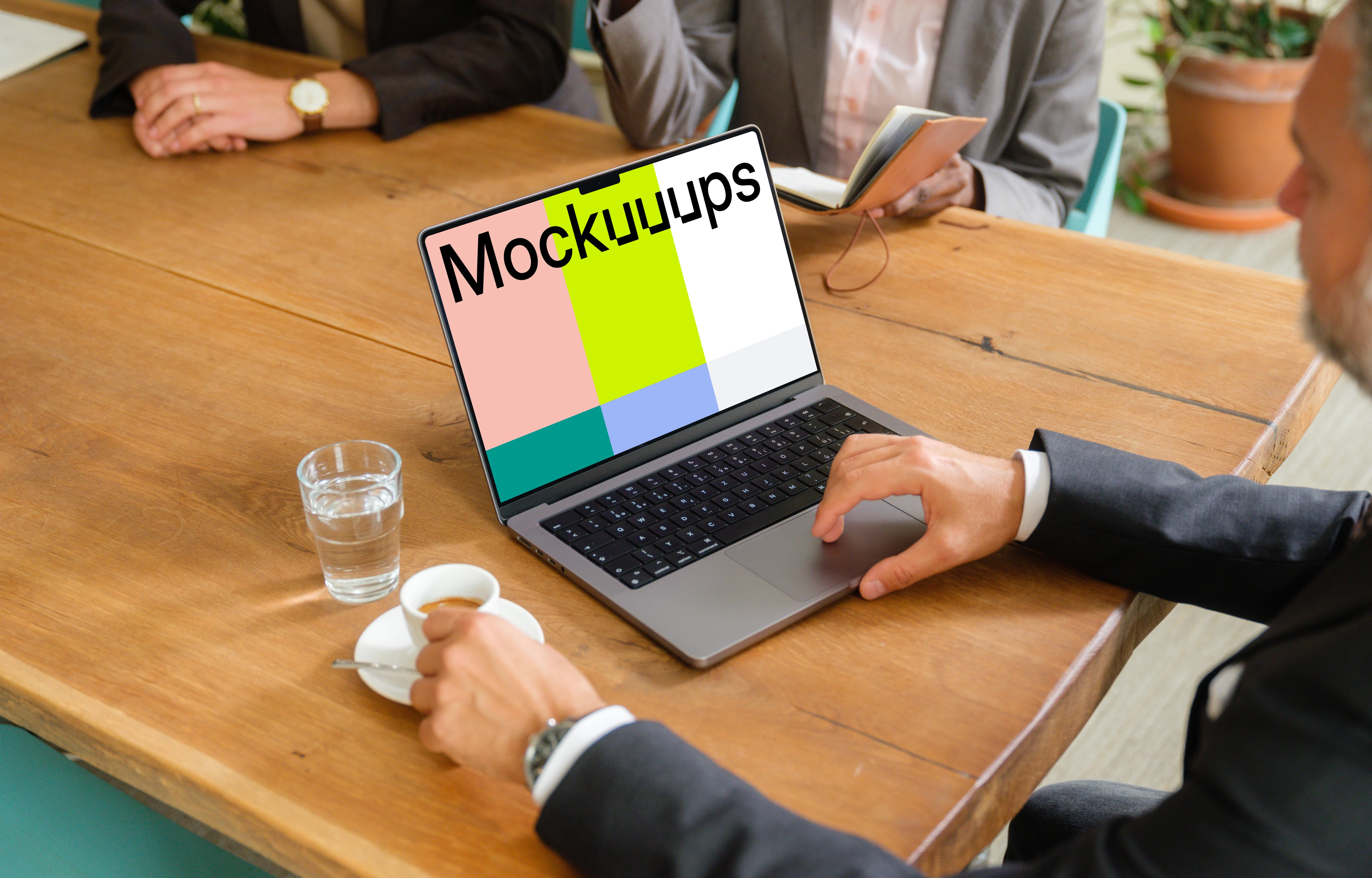 Businessman working on a MacBook during business meeting