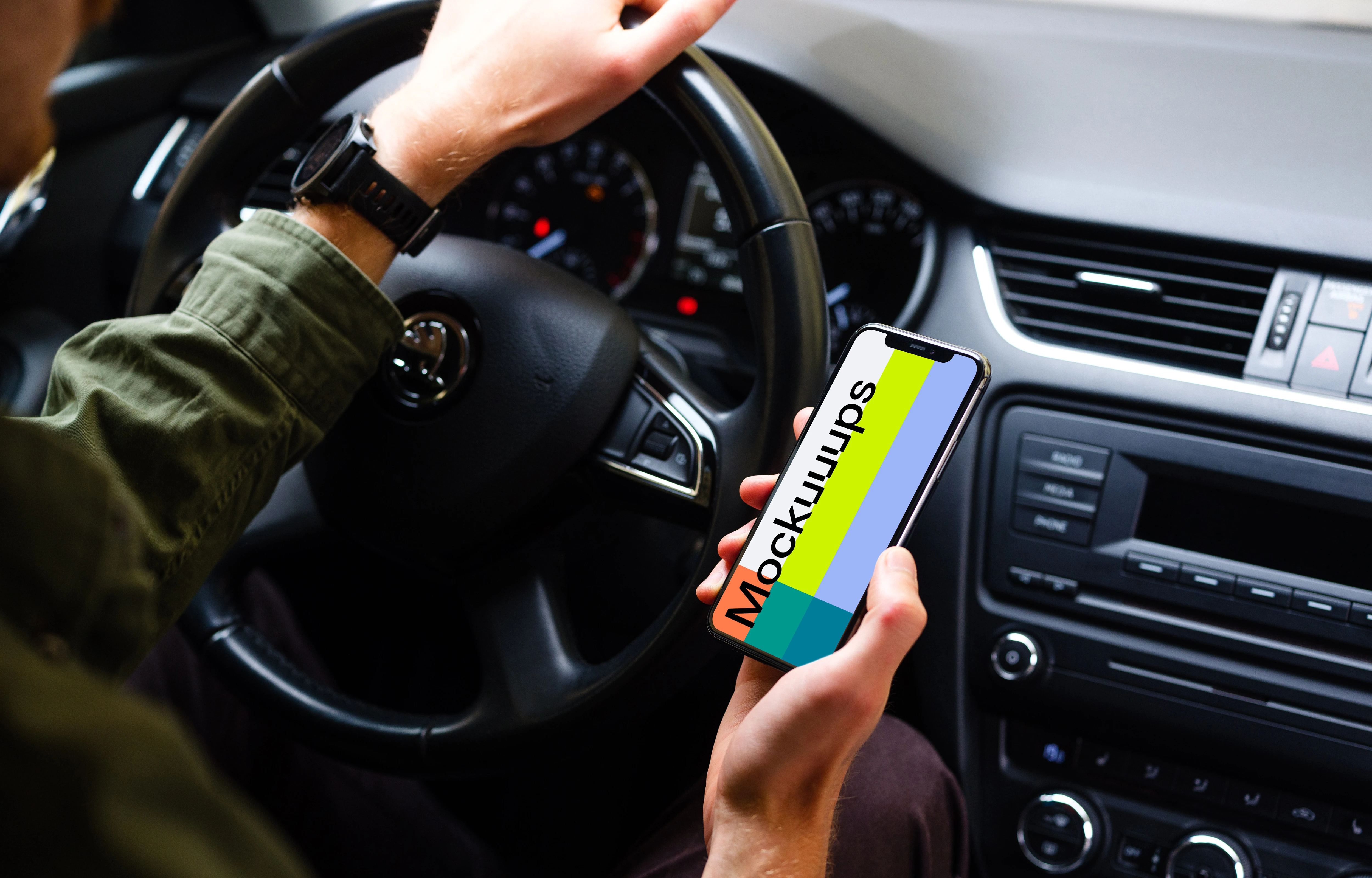 Driver holding an iPhone 11 mockup with hand on wheel
