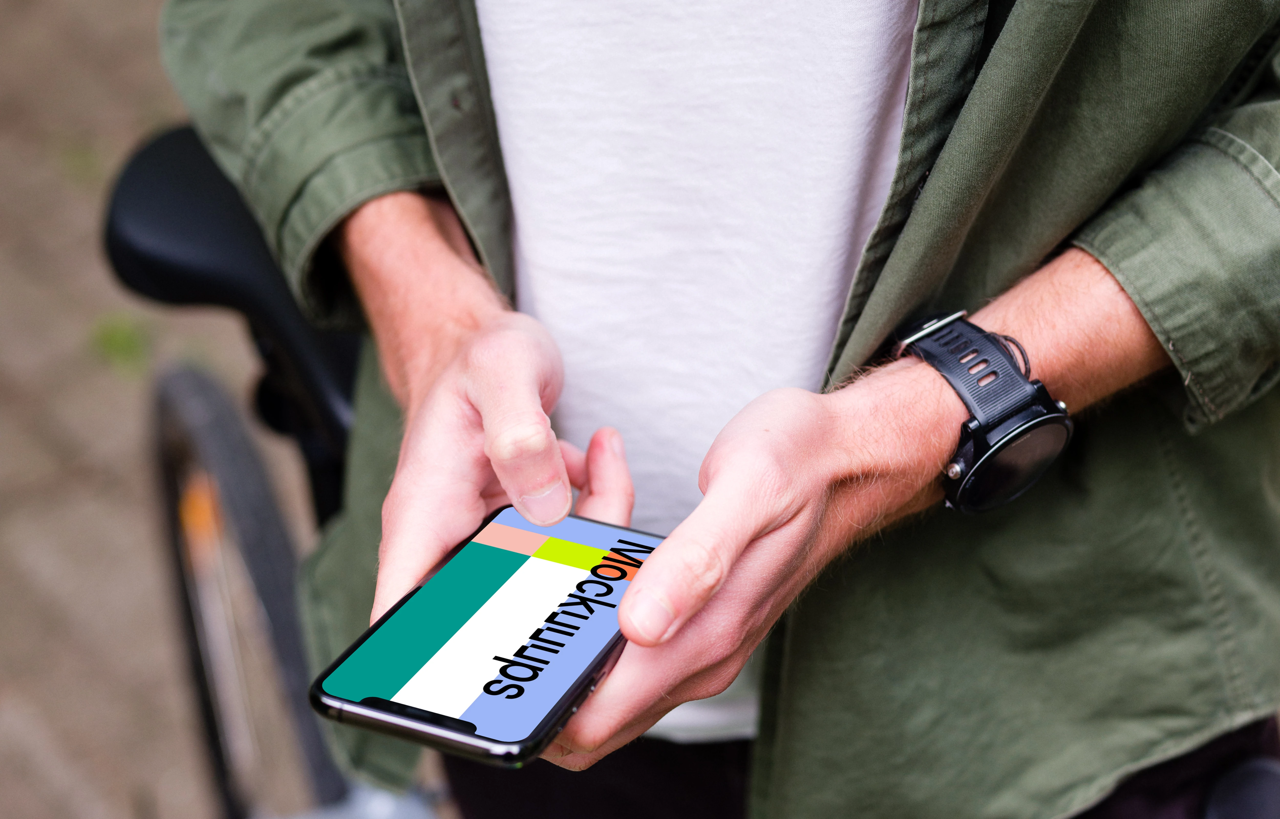 Typing on an iPhone 11 Pro mockup whilst stood with a bike