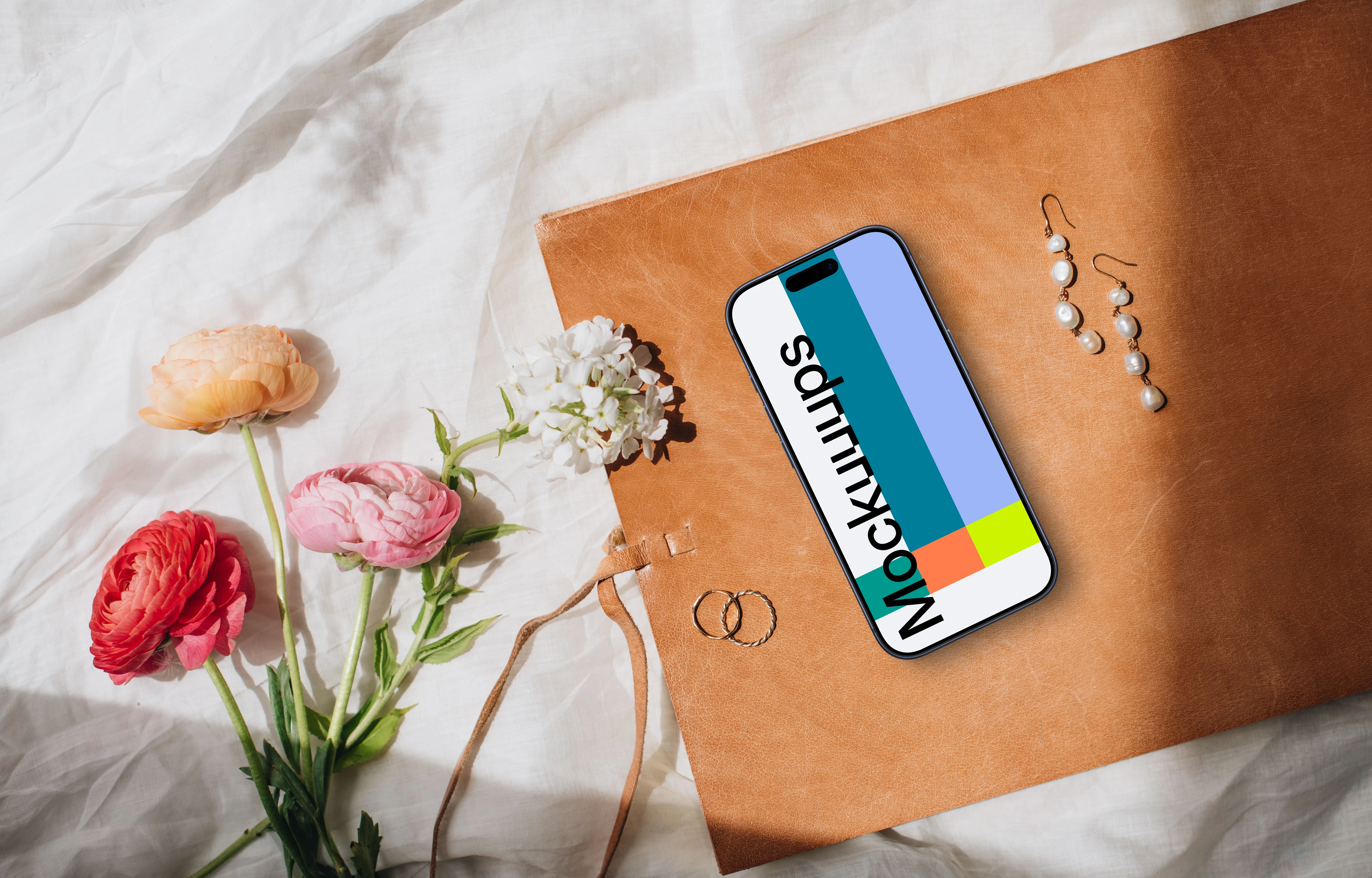 Flowers, wedding rings and iPhone mockup