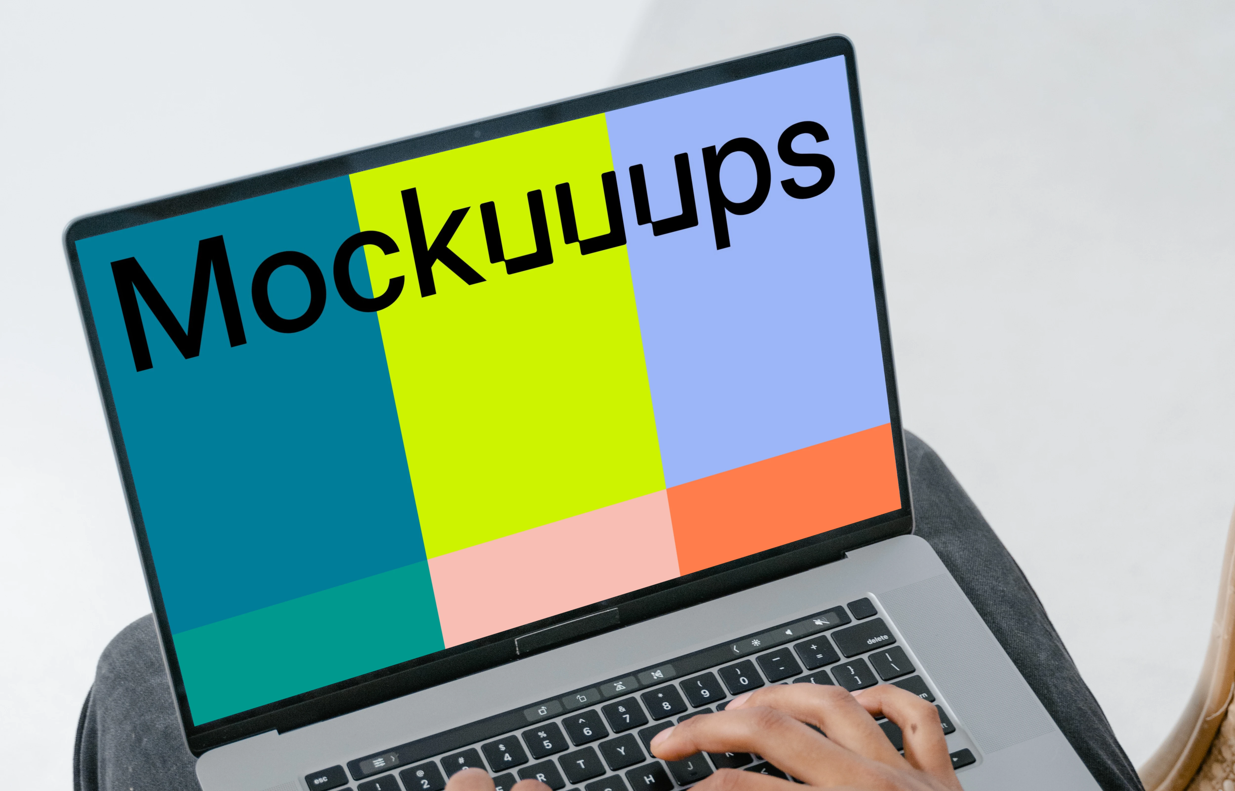 Grey MacBook mockup on a user’s lap