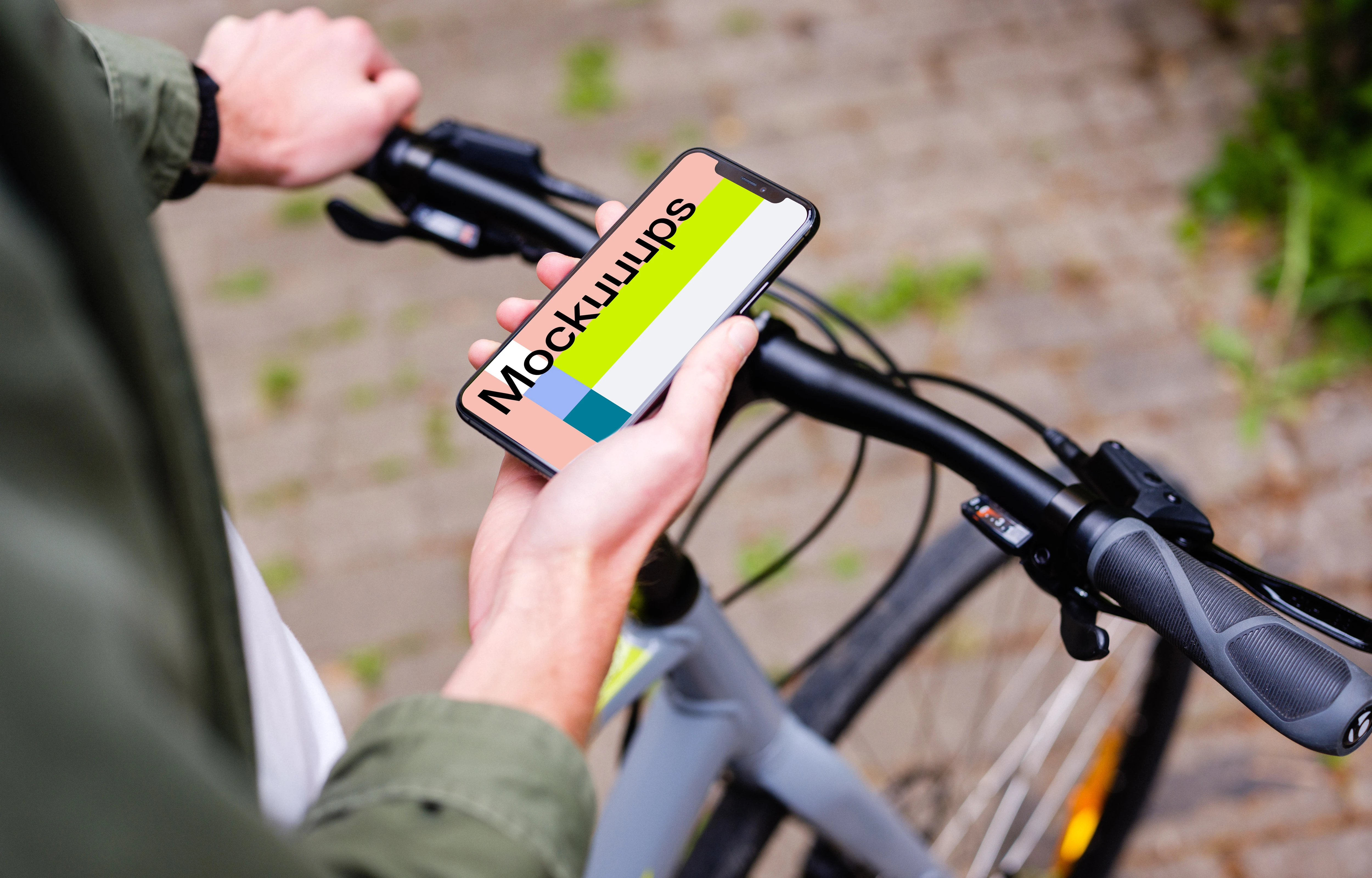 Holding an iPhone 11 Pro mockup while waiting on a bike