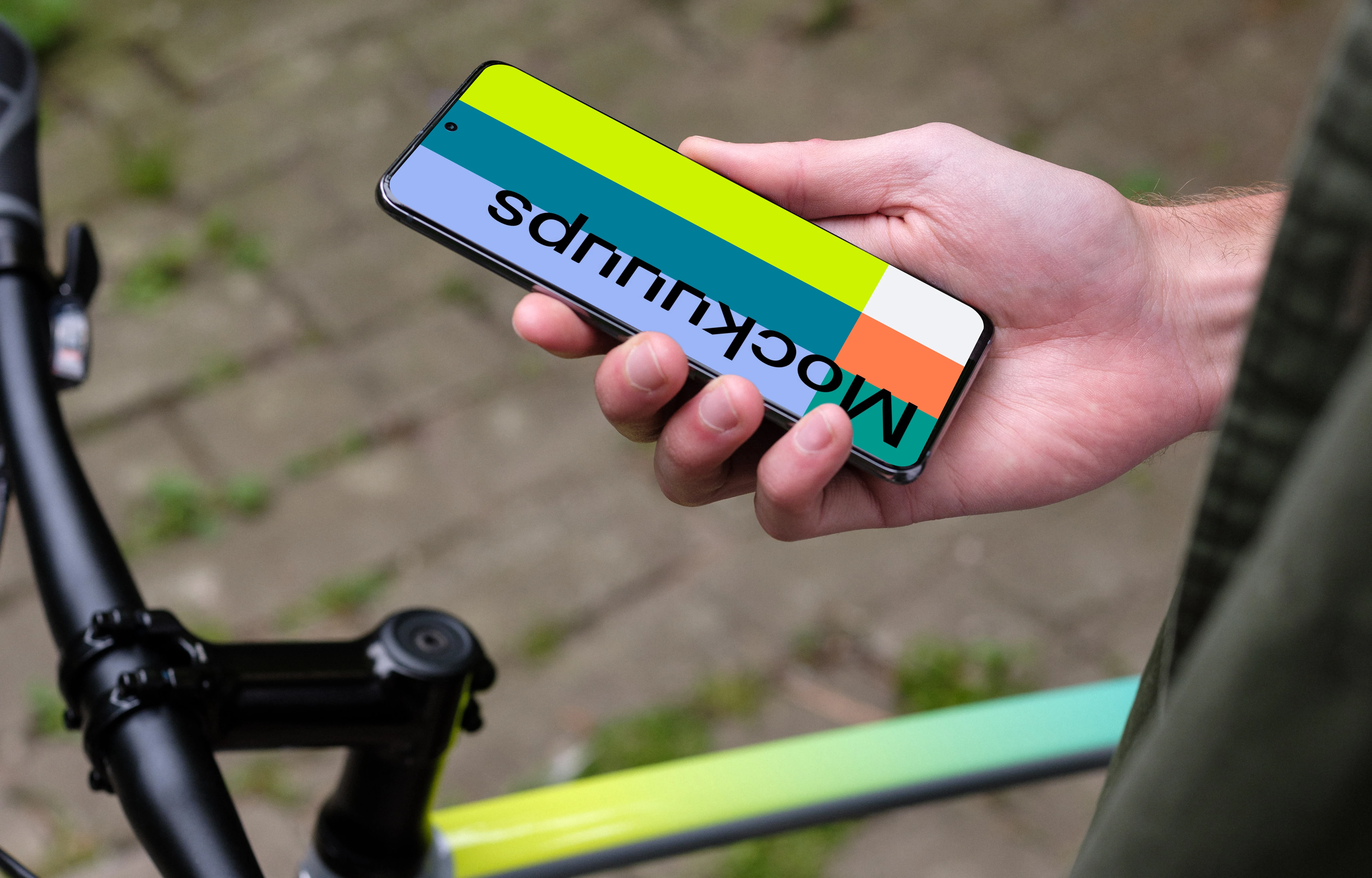 Holding Samsung S20 mockup in one hand next to a bike