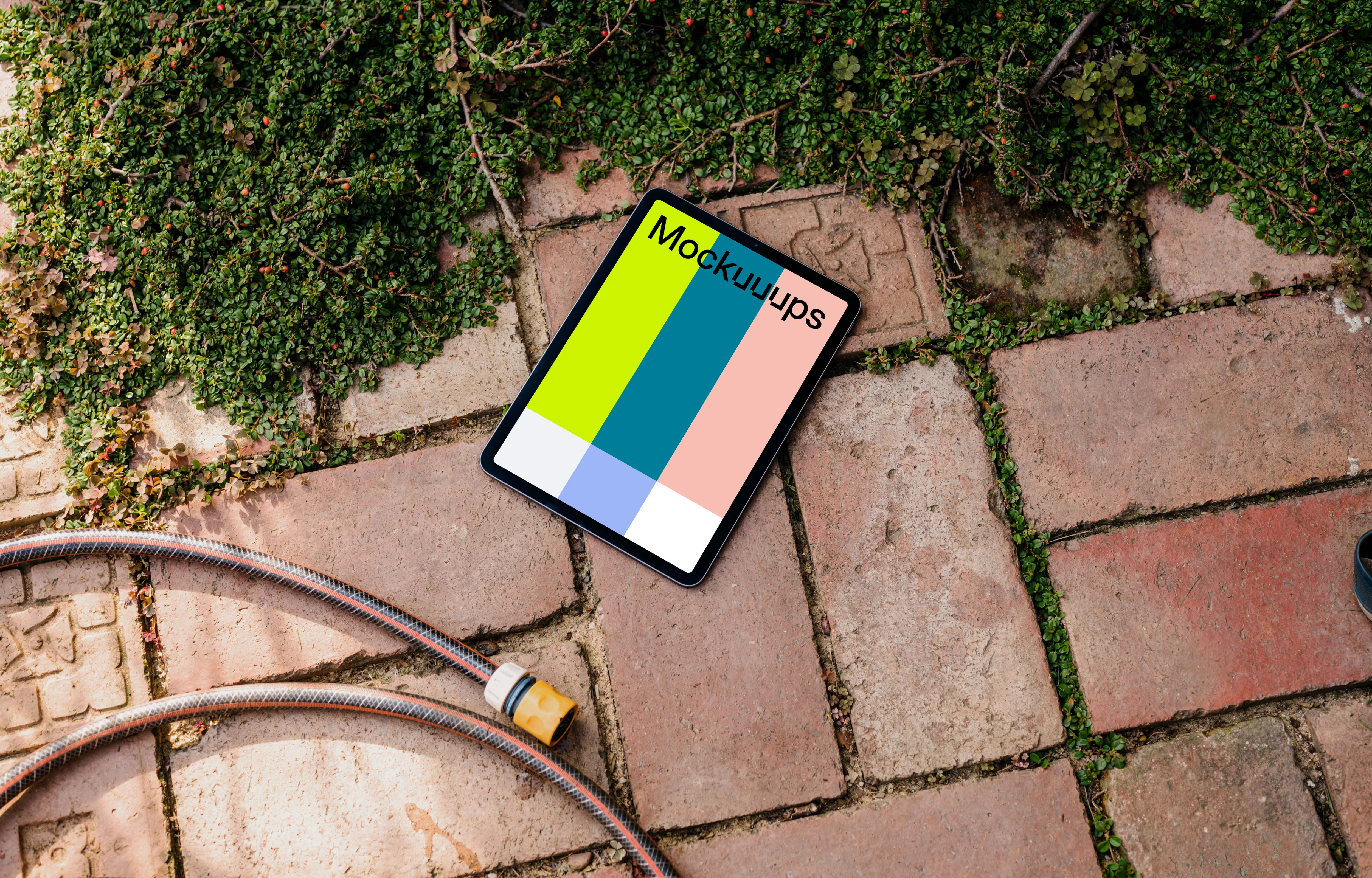 iPad Air mockup on a garden paving with plants
