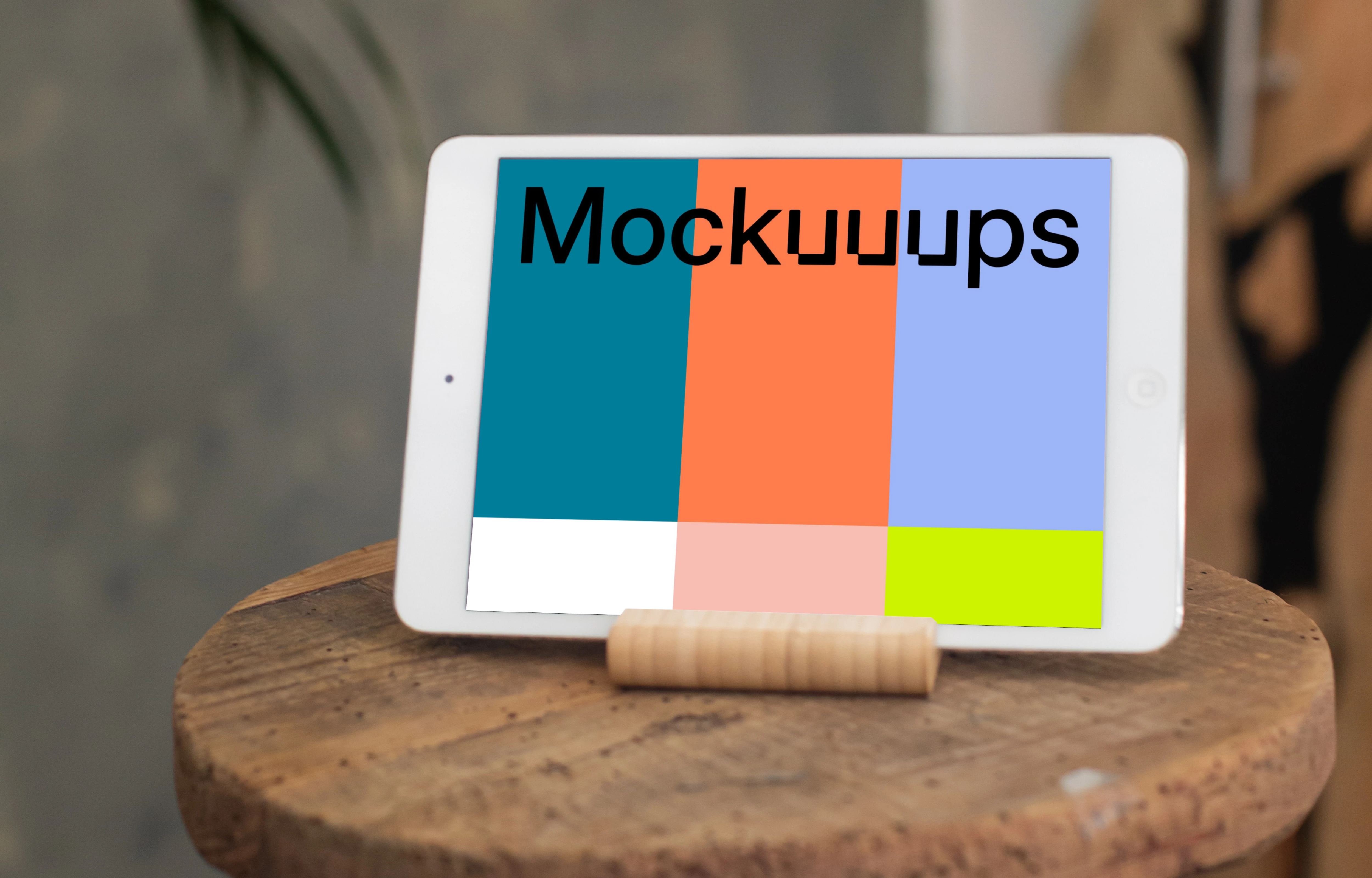 iPad Mini mockup in landscape mode placed on a wooden stool