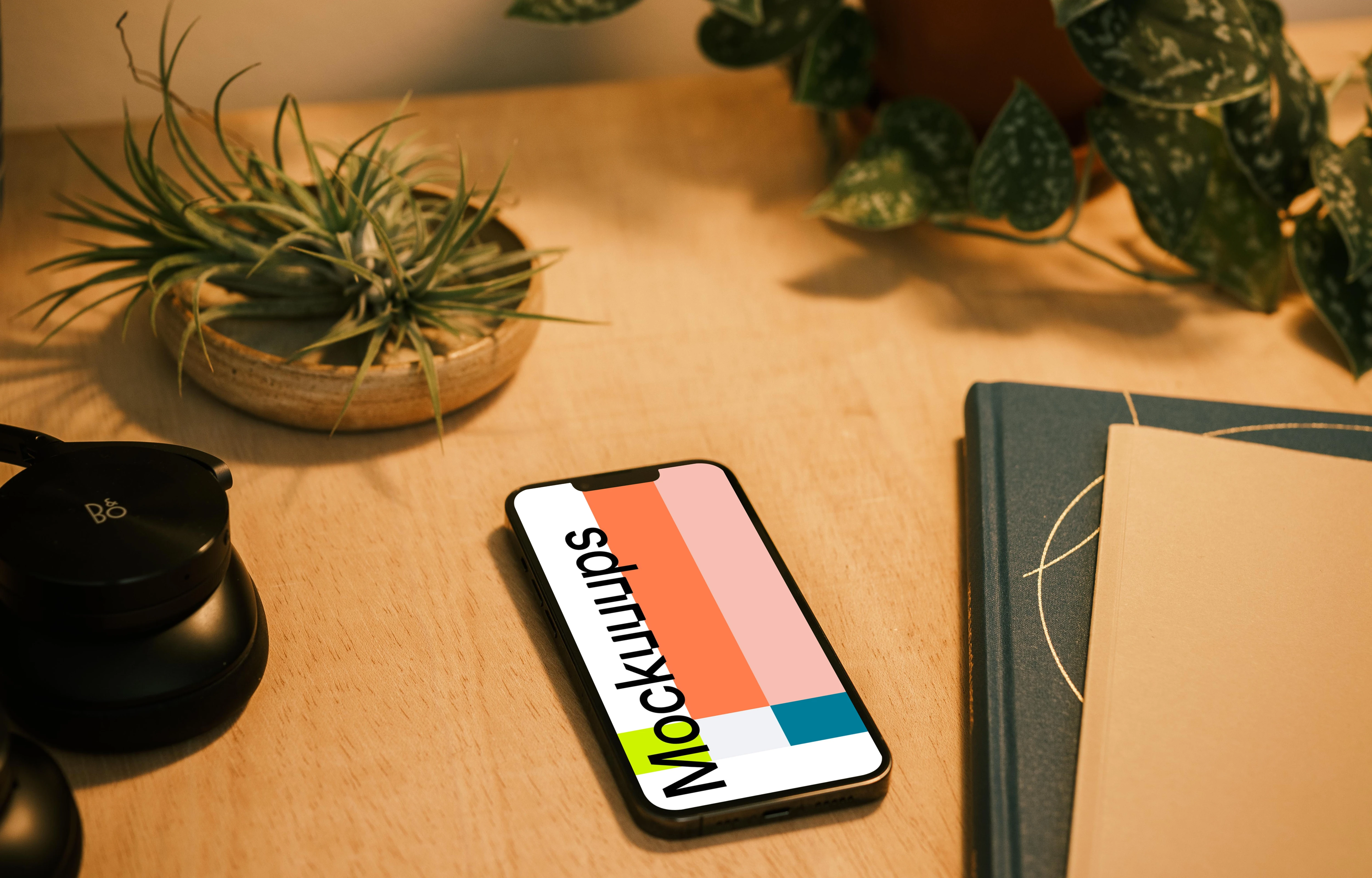 iPhone 13 Pro on a table with potted plants in the background