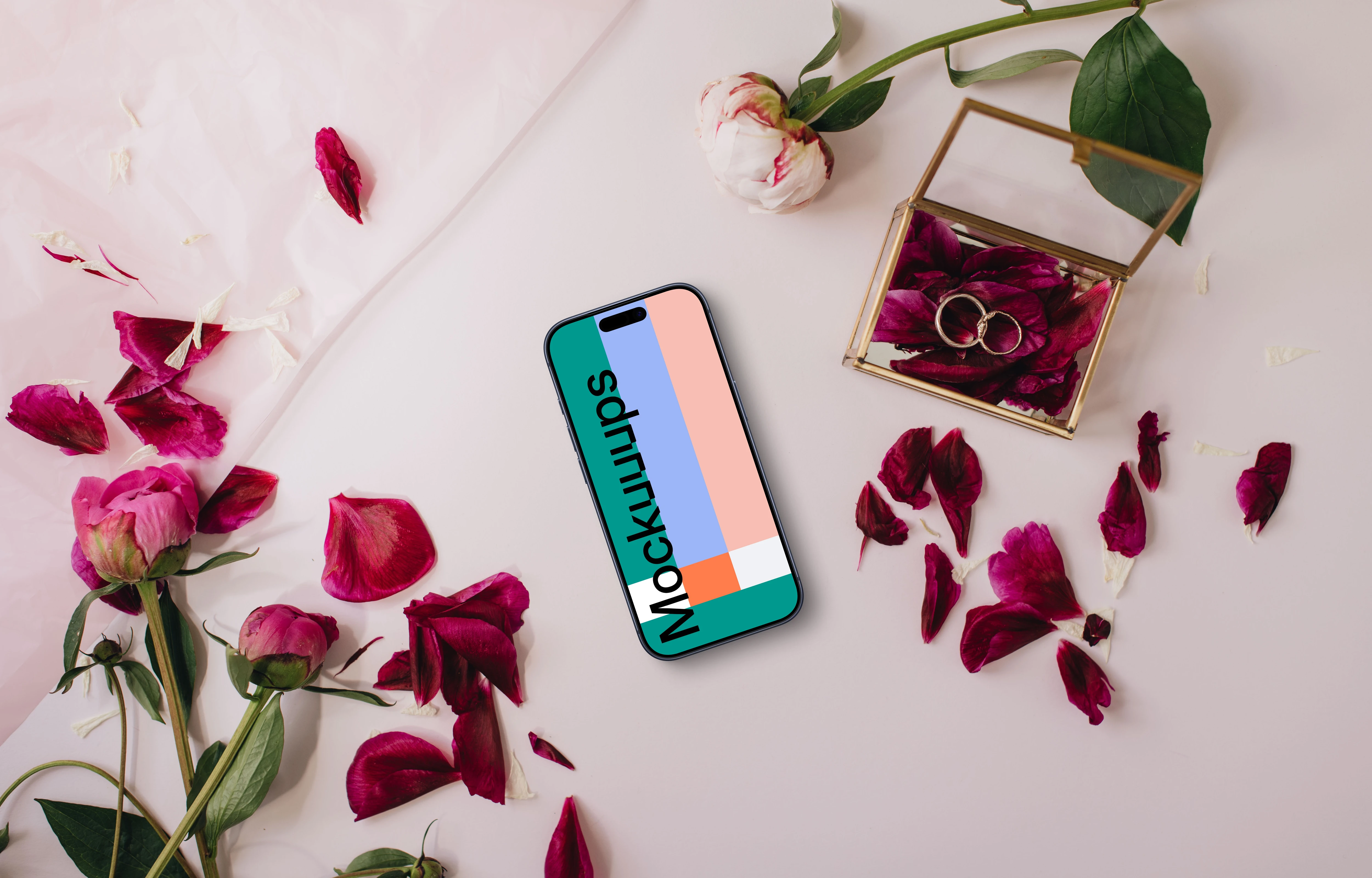 iPhone cercado por pétalas de rosa