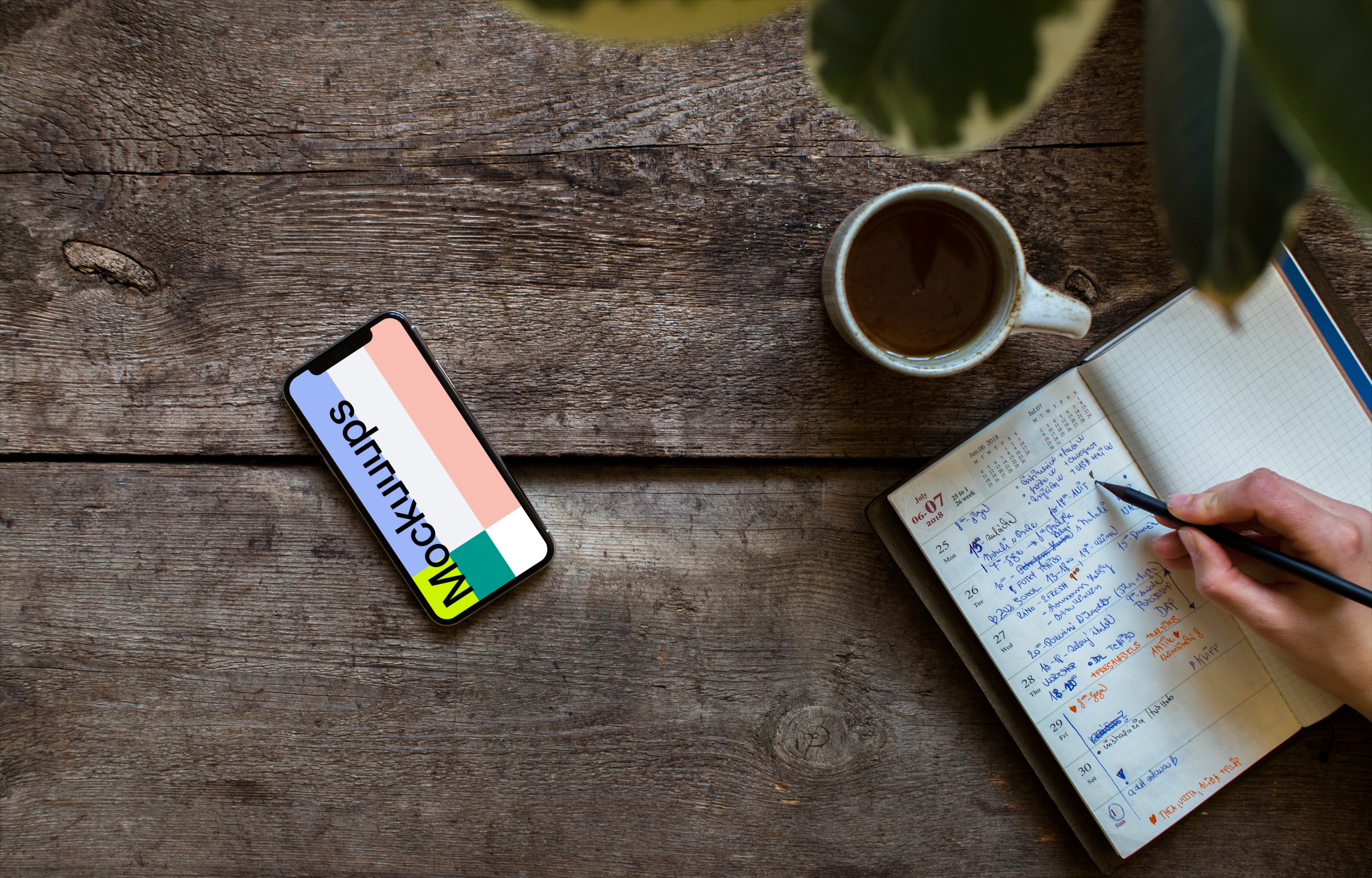 iPhone XS mockup with a journal on the right side