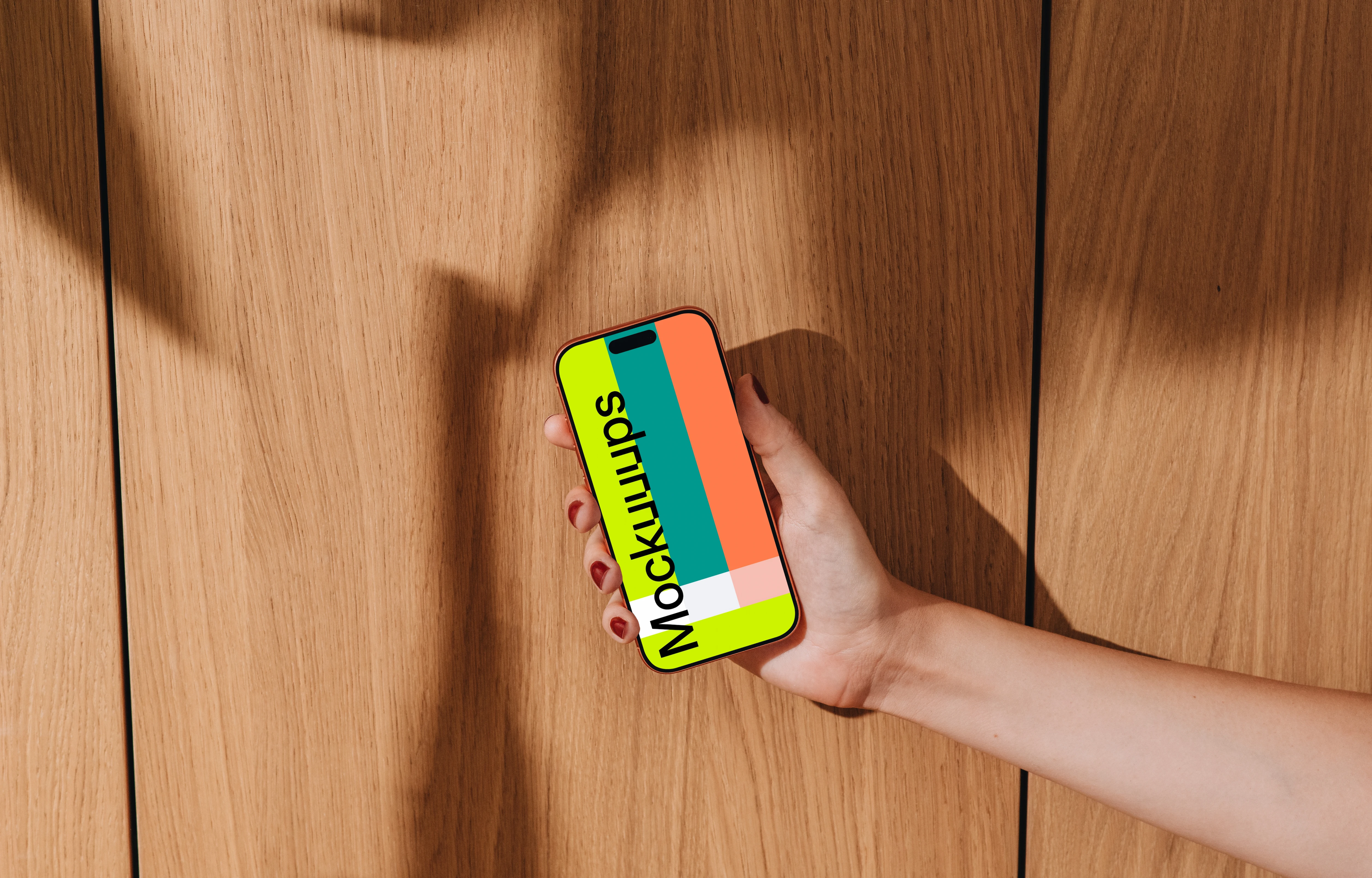 iPhone 17 Pro mockup held against a wooden background