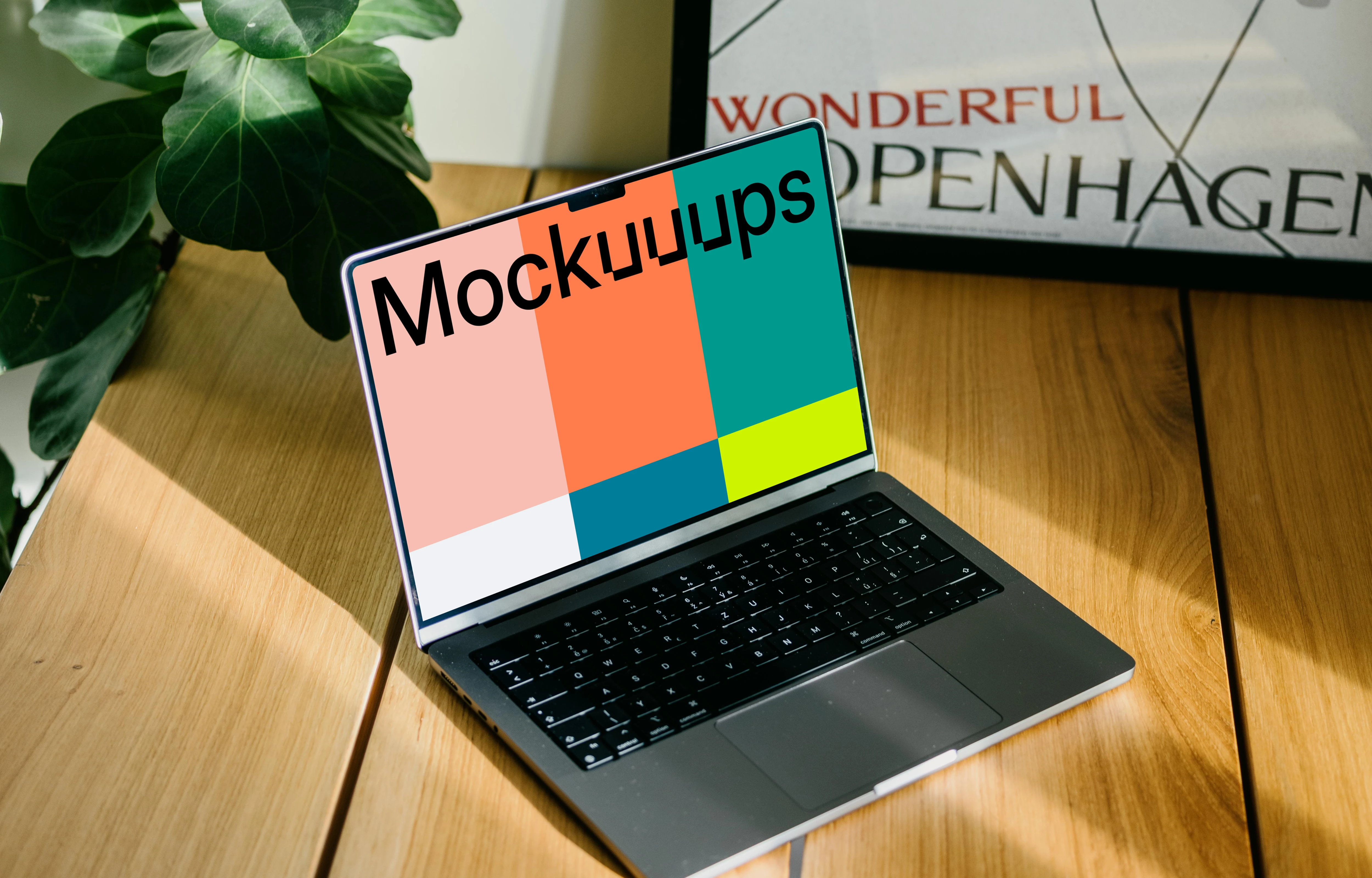 Laptop mockup with a plant in the background