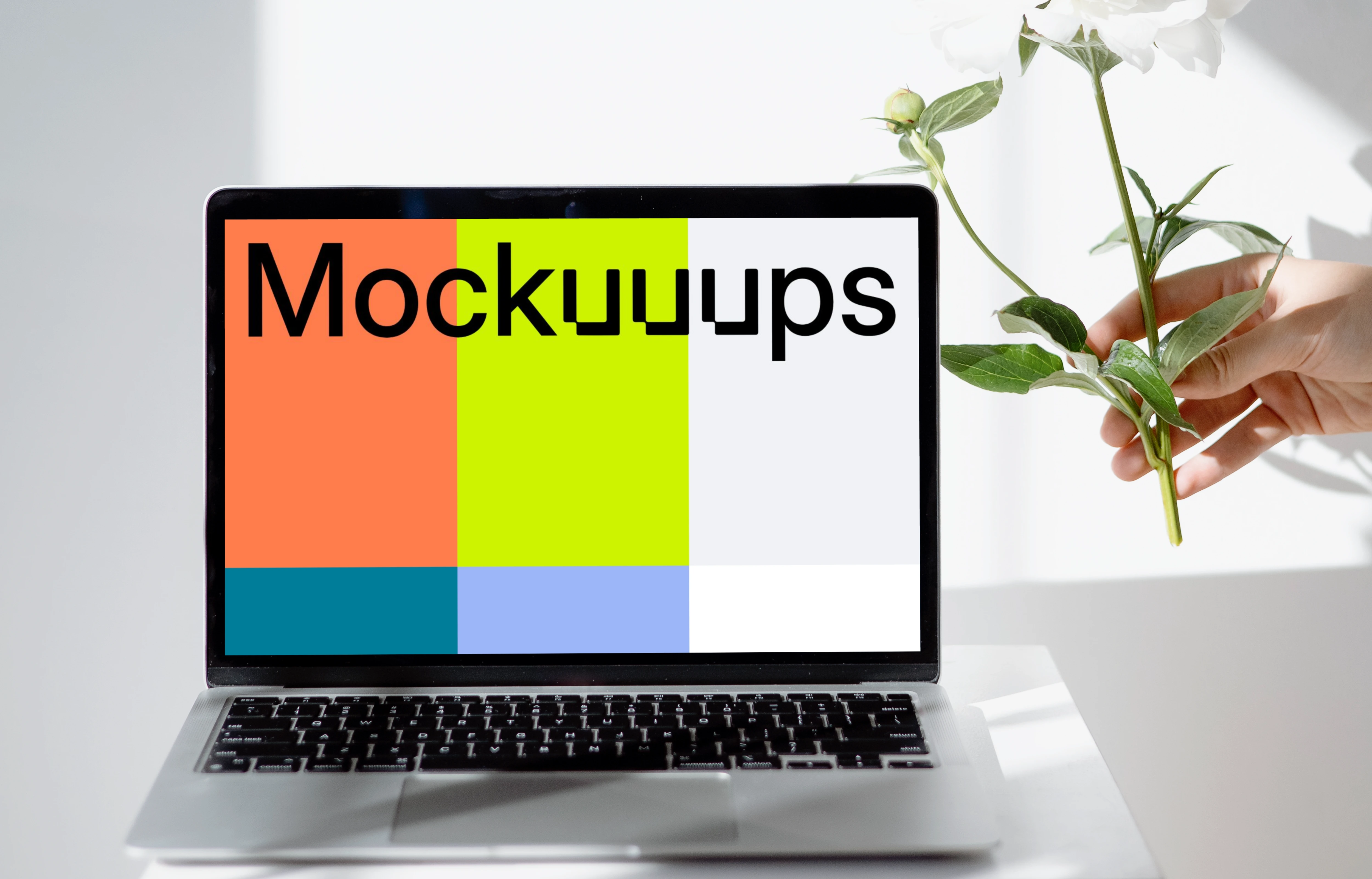 MacBook mockup on a white table close to the window