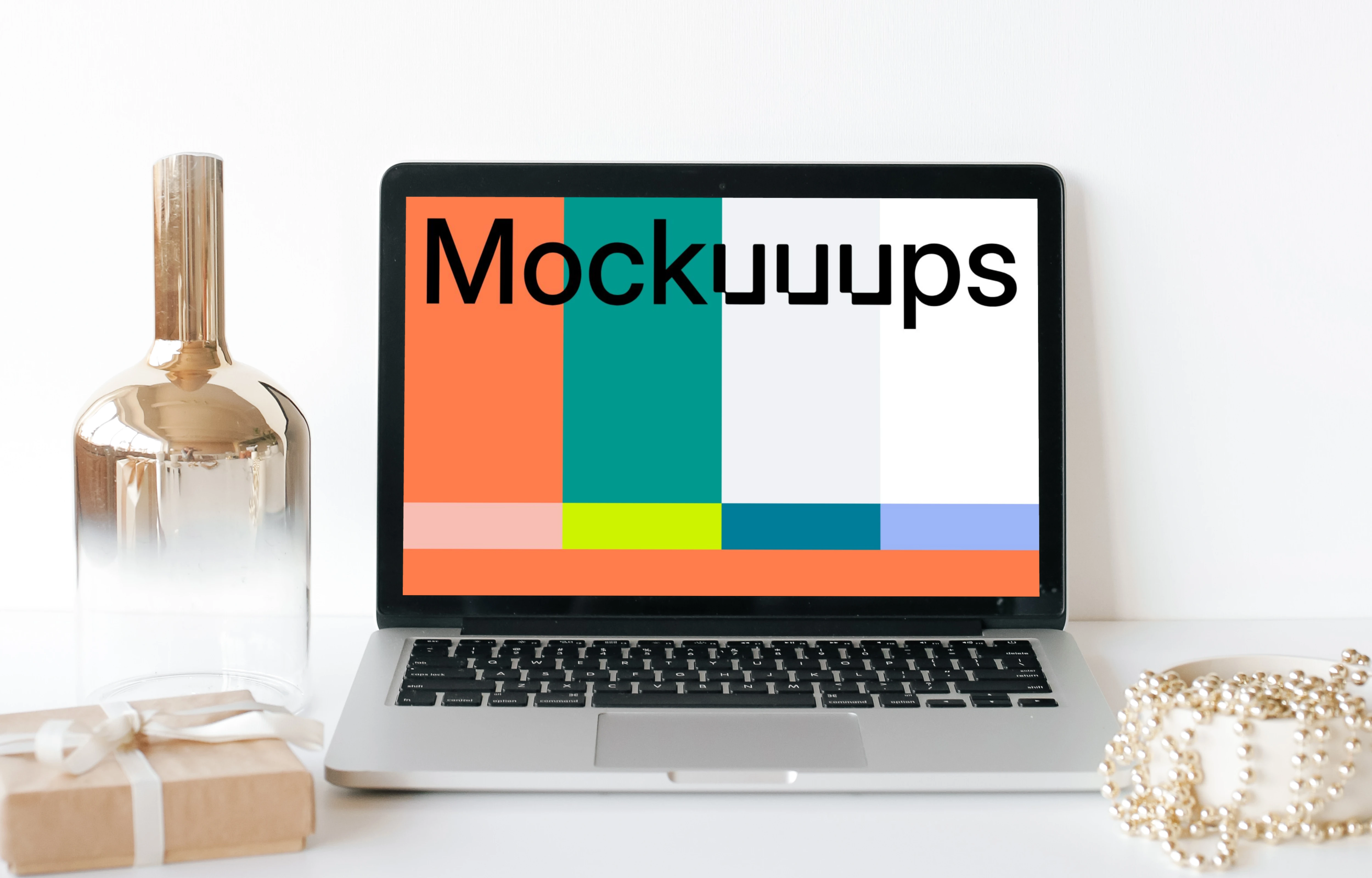 MacBook mockup on a white table with a glass jar at the side