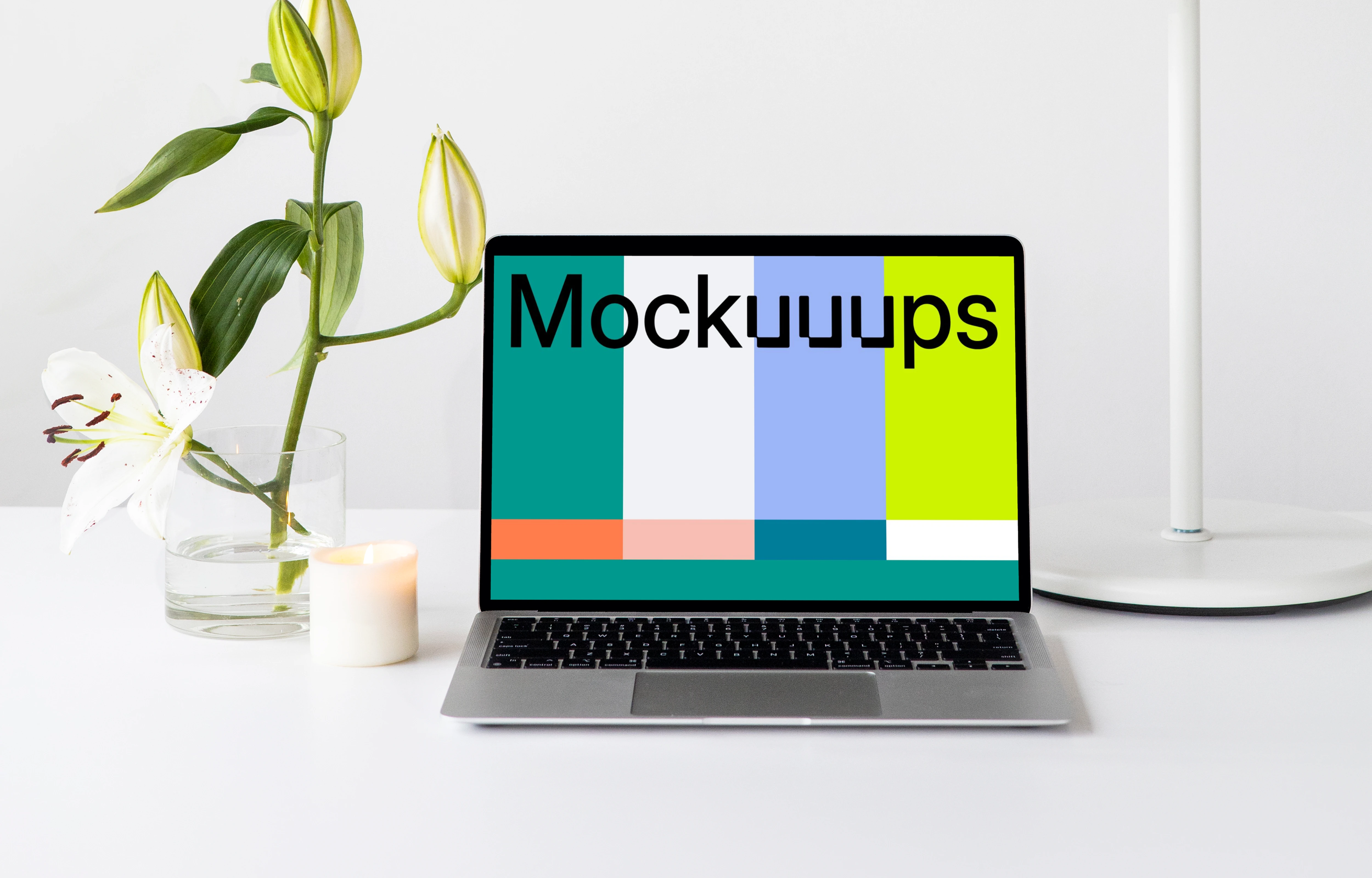 MacBook mockup on a white table with white table lamp at the side