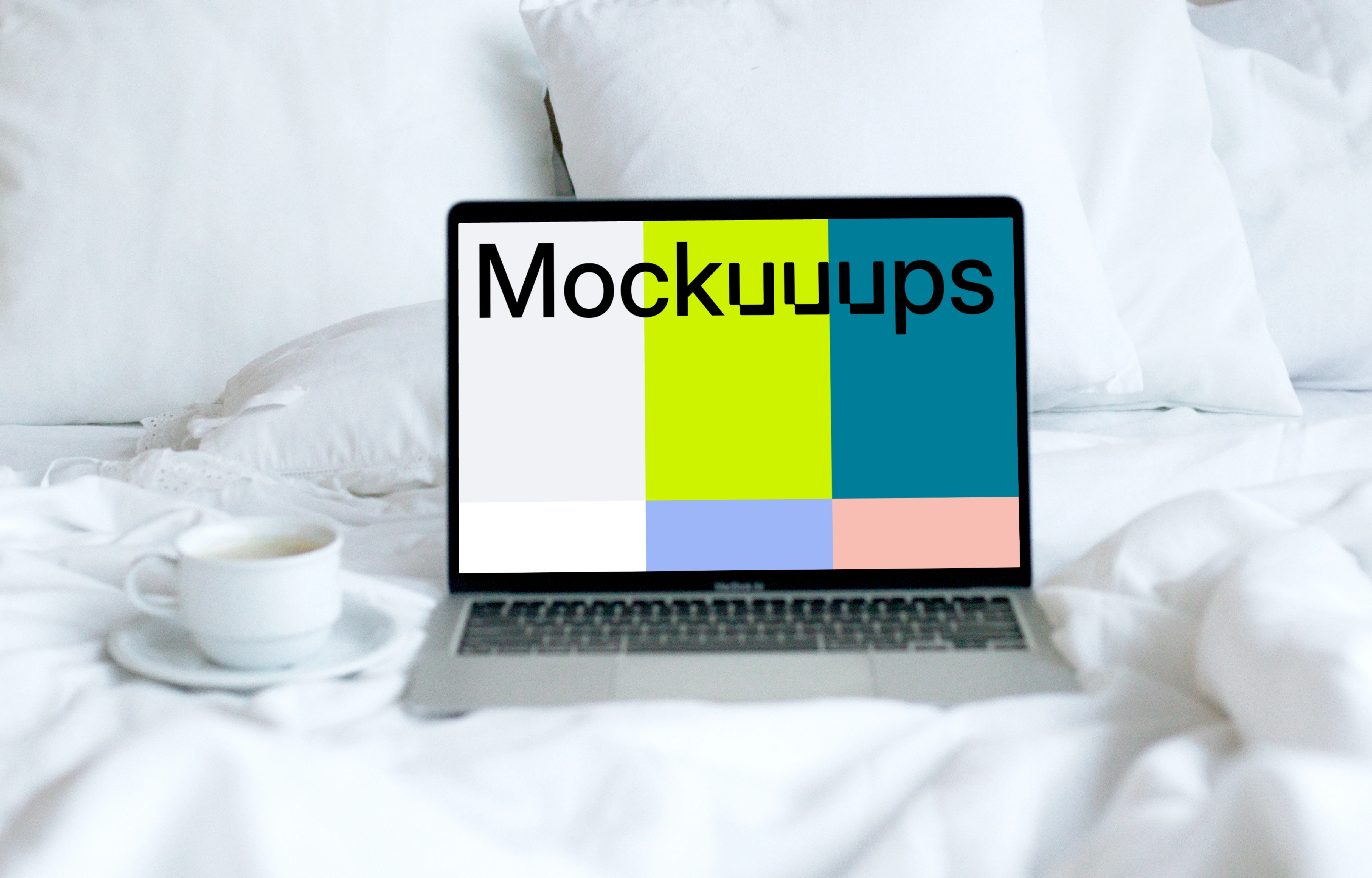 MacBook mockup placed on a white bed with a cup of coffee at the side